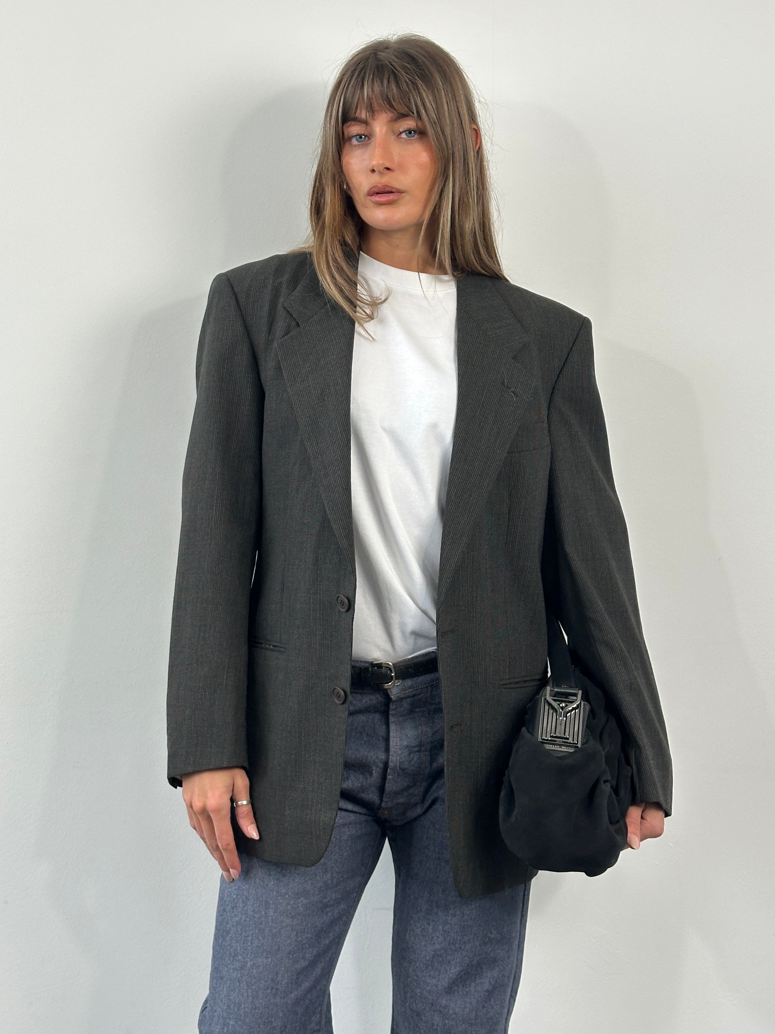 Yves Saint Laurent 1990s pure wool single-breasted blazer in size 40R/M, dark tailored blazer with notch lapels and structured fit.