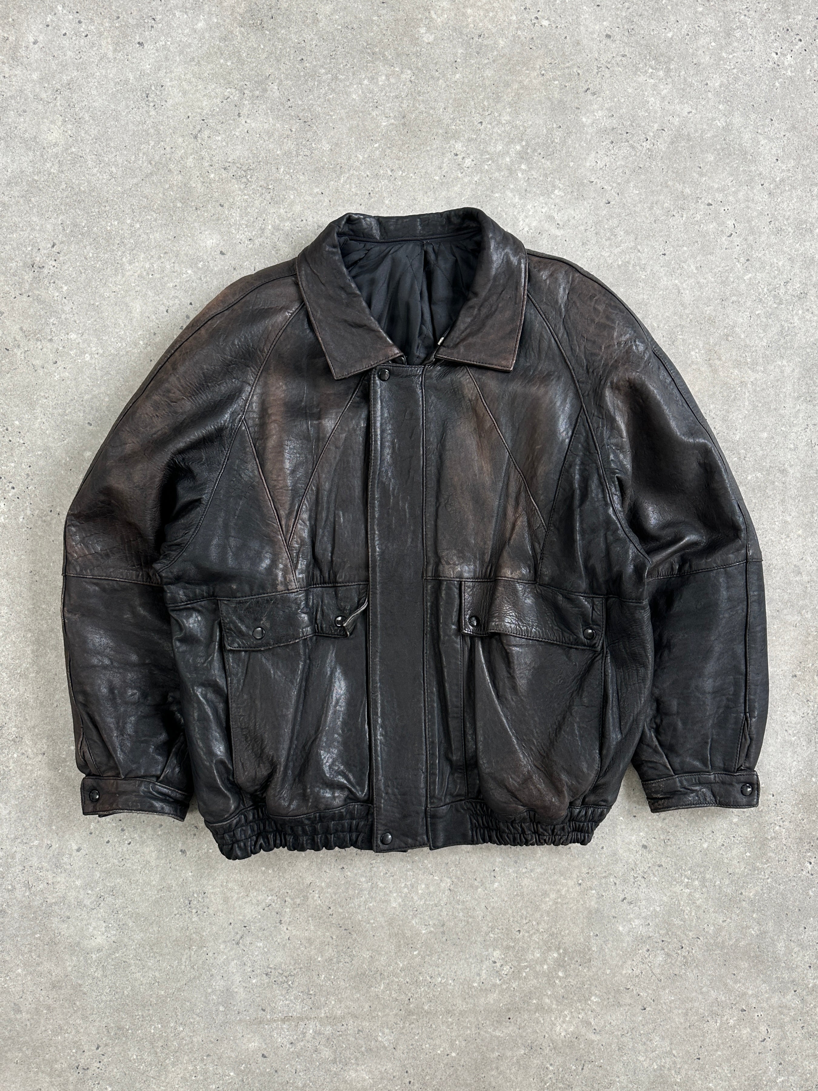 Vintage brand aged leather bomber jacket in size XL, featuring worn leather and classic 1980s style with detailed stitching.