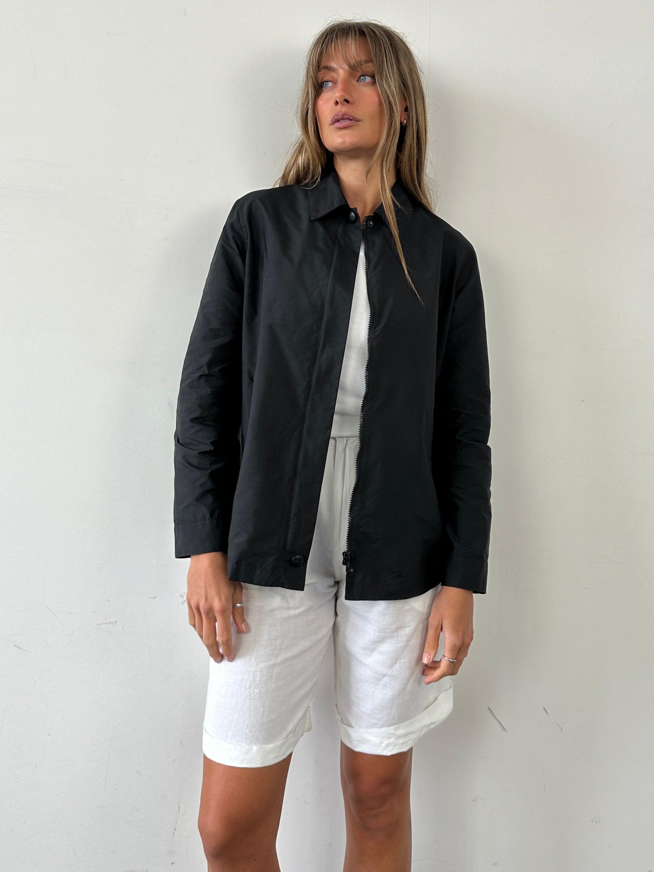Max Mara Weekend concealed placket bomber jacket in size M, navy color, with ribbed cuffs and collar, displayed on a hanger.