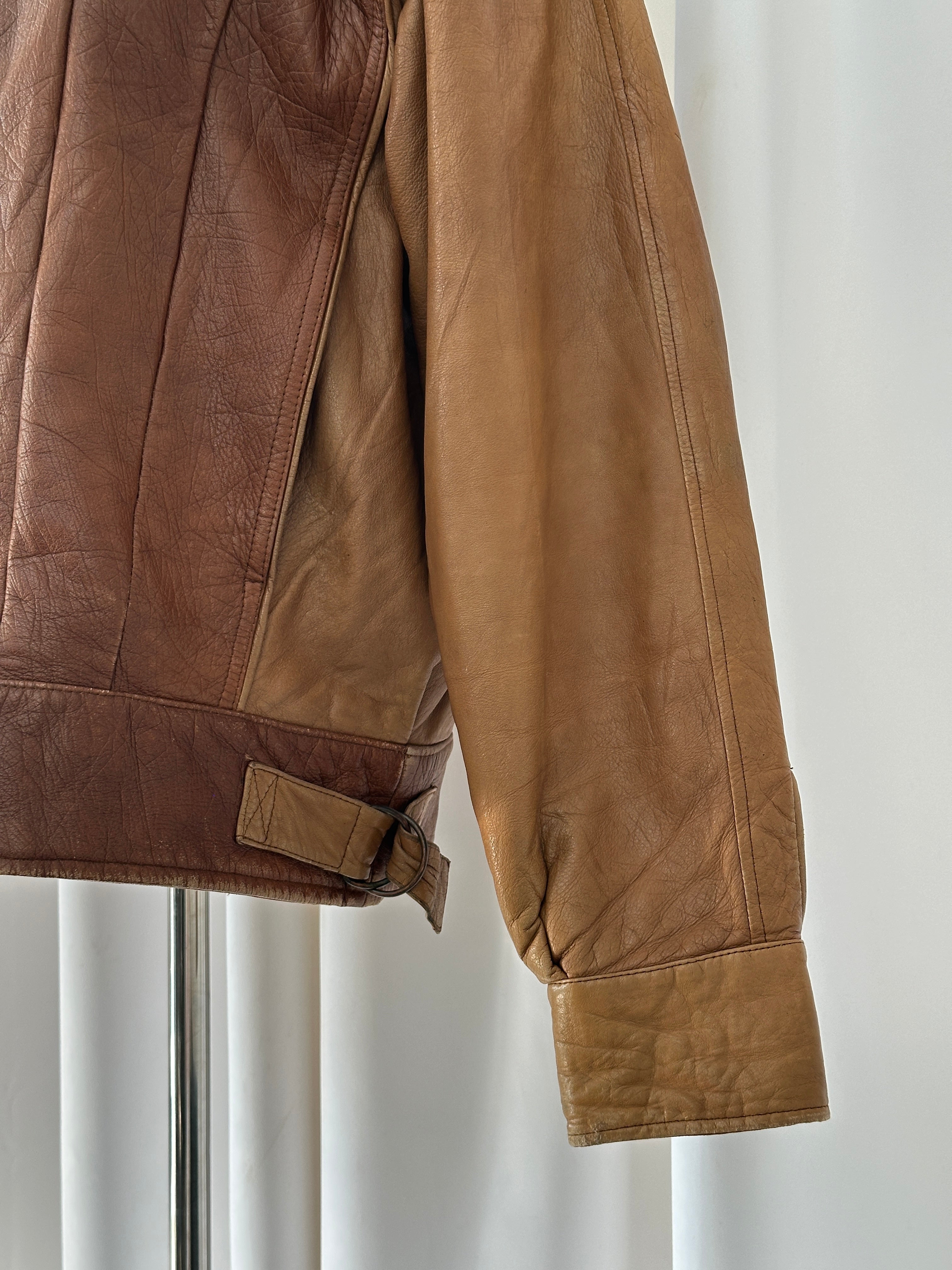 Vintage Italian 1980s leather bomber jacket with classic design, black leather, and ribbed cuffs, in M/L size.