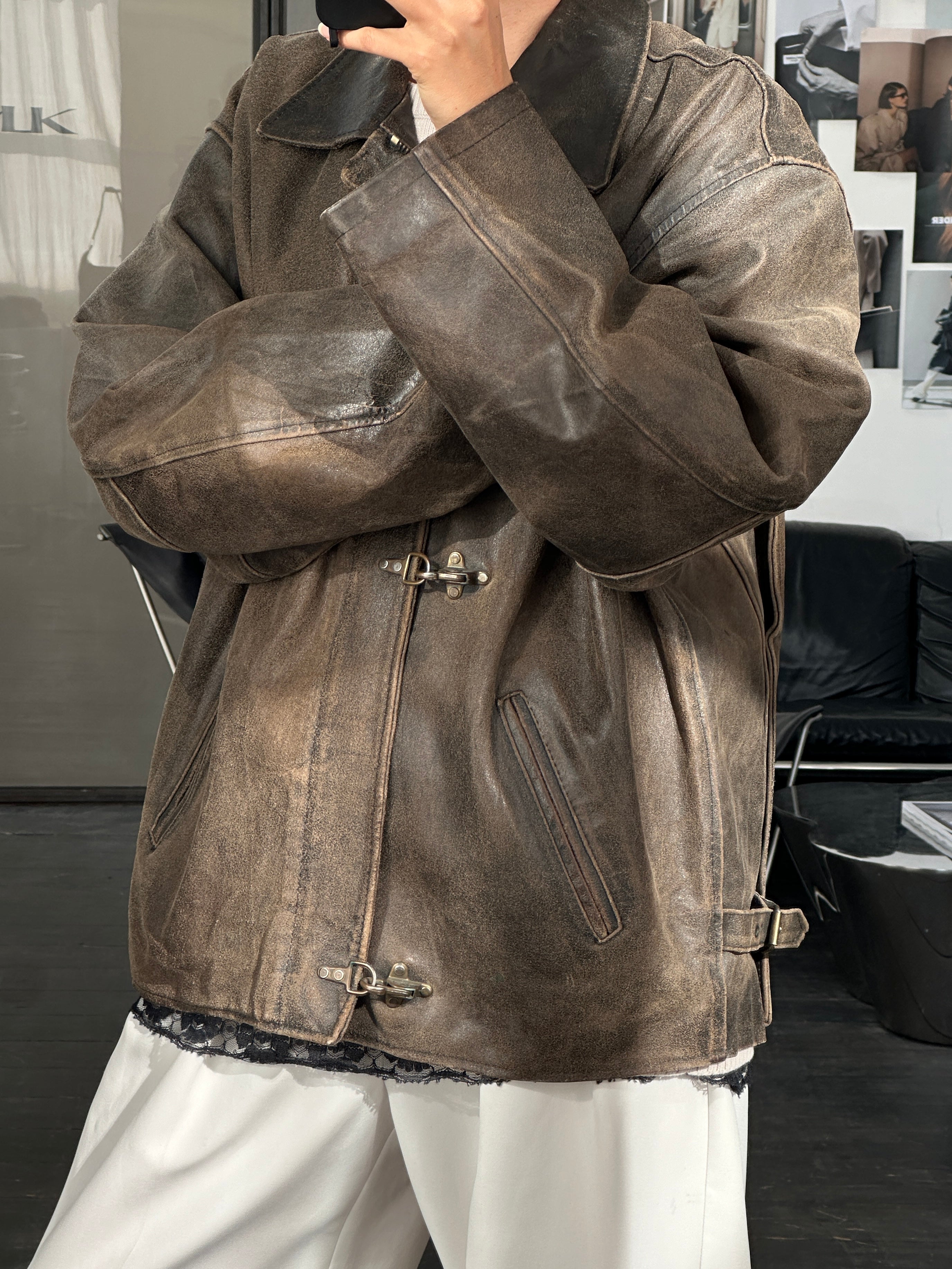 Vintage 1980s distressed leather jacket in XL size with rugged texture and classic style, worn and stylish, on a plain background.