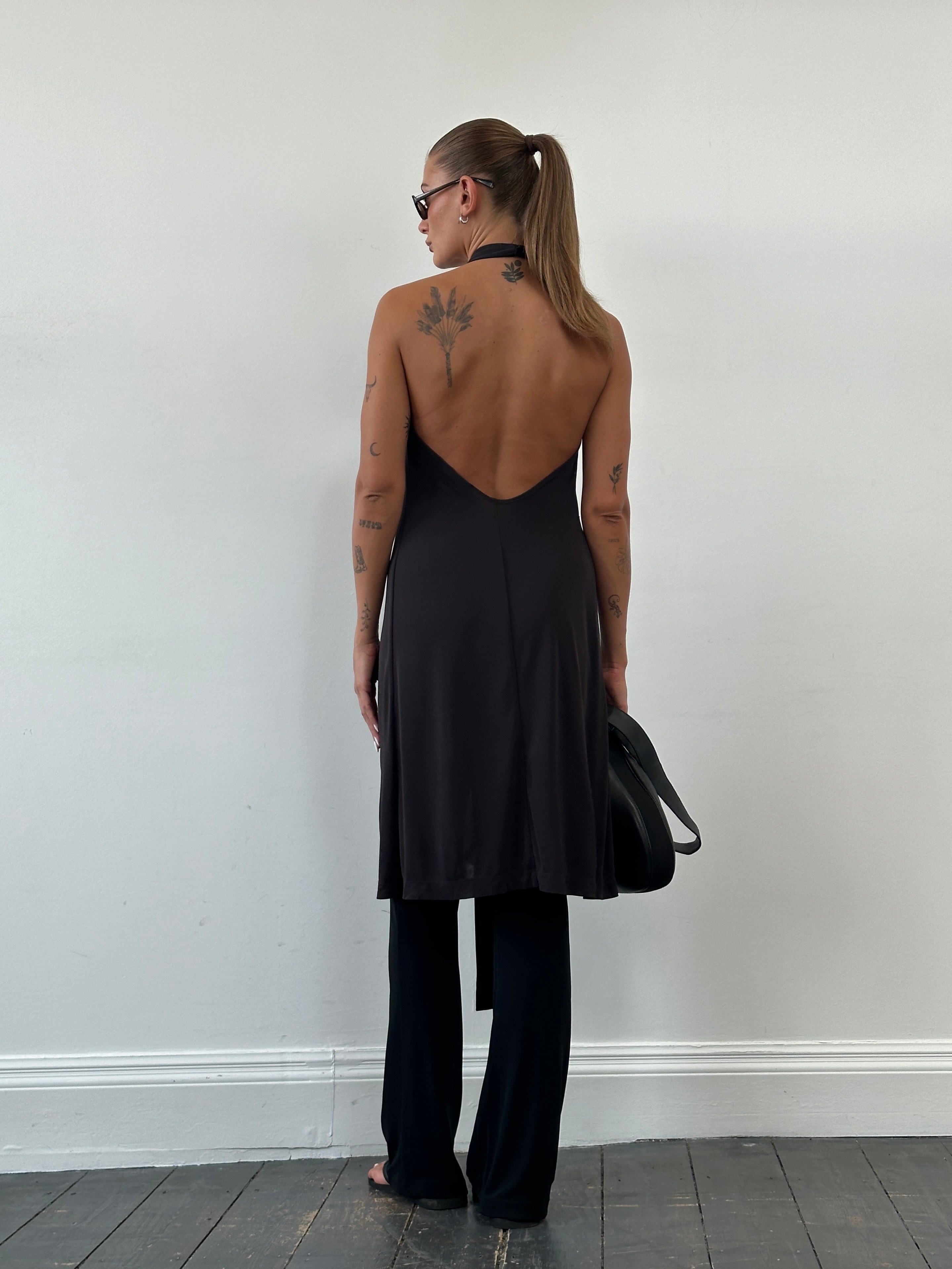 Max & Co wrap mini dress in black with long sleeves, fitted waist, and V-neck, displayed on a hanger.
