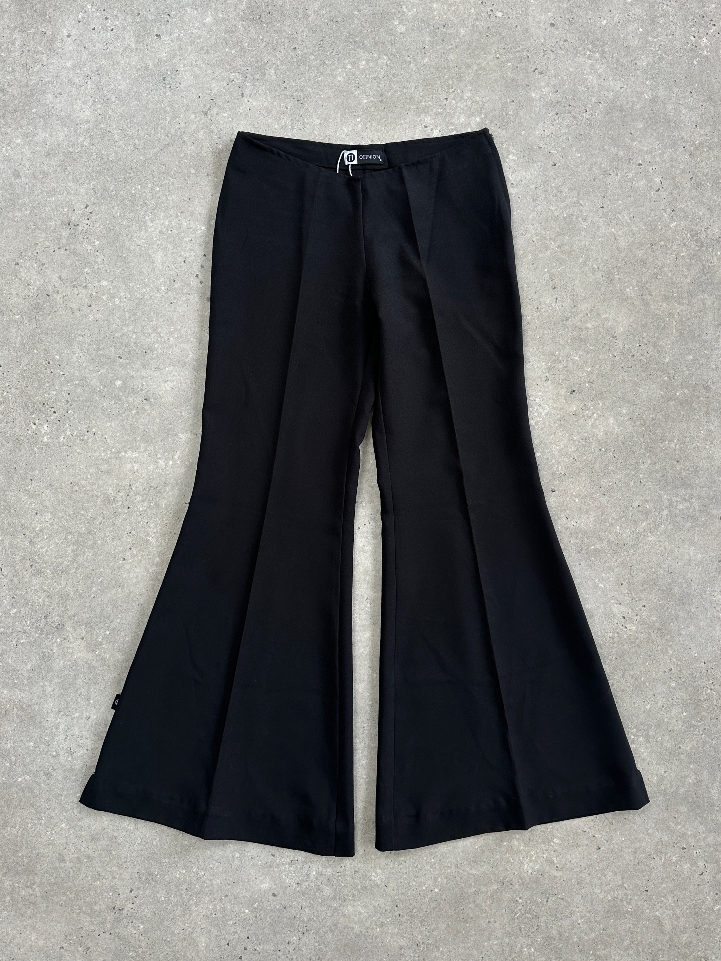 Vintage 1990s flared trousers in W28 style, showing the wide-leg design and retro denim fabric with subtle fading.