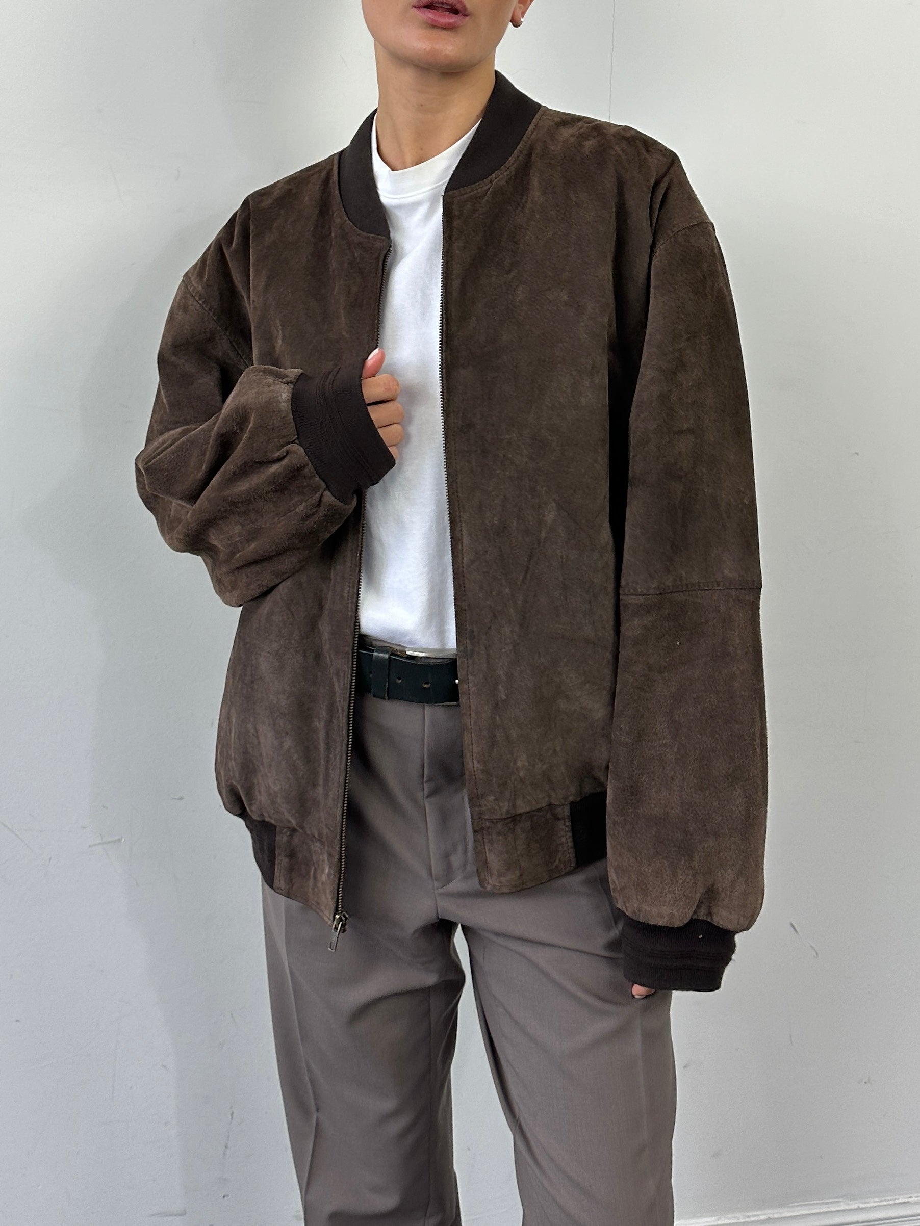 Vintage suede leather bomber jacket in XL, showcasing classic design and textured material with a fitted collar and zip closure.