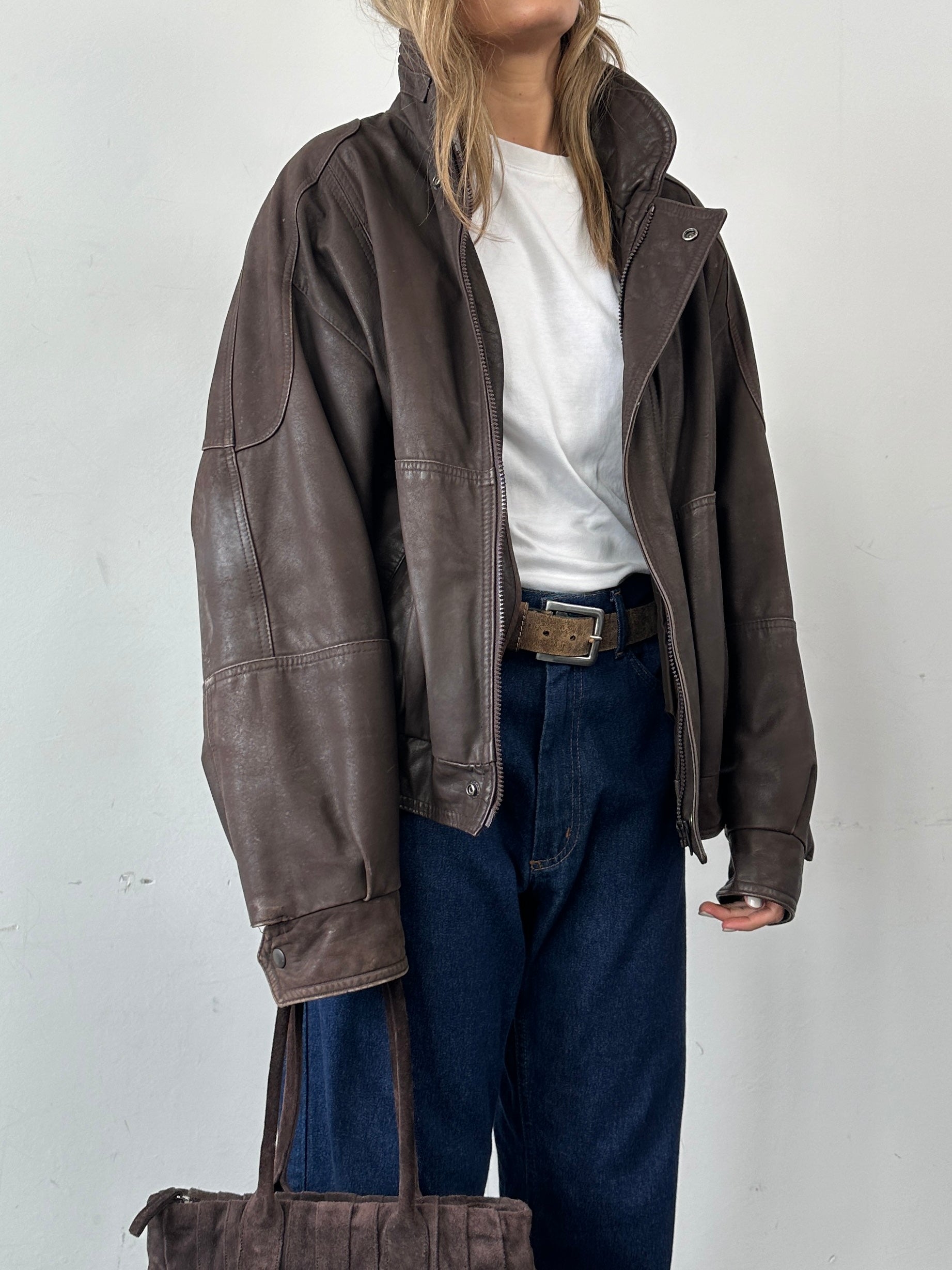 Vintage leather bomber jacket in XL size, featuring classic design with a rugged leather finish and ribbed collar.