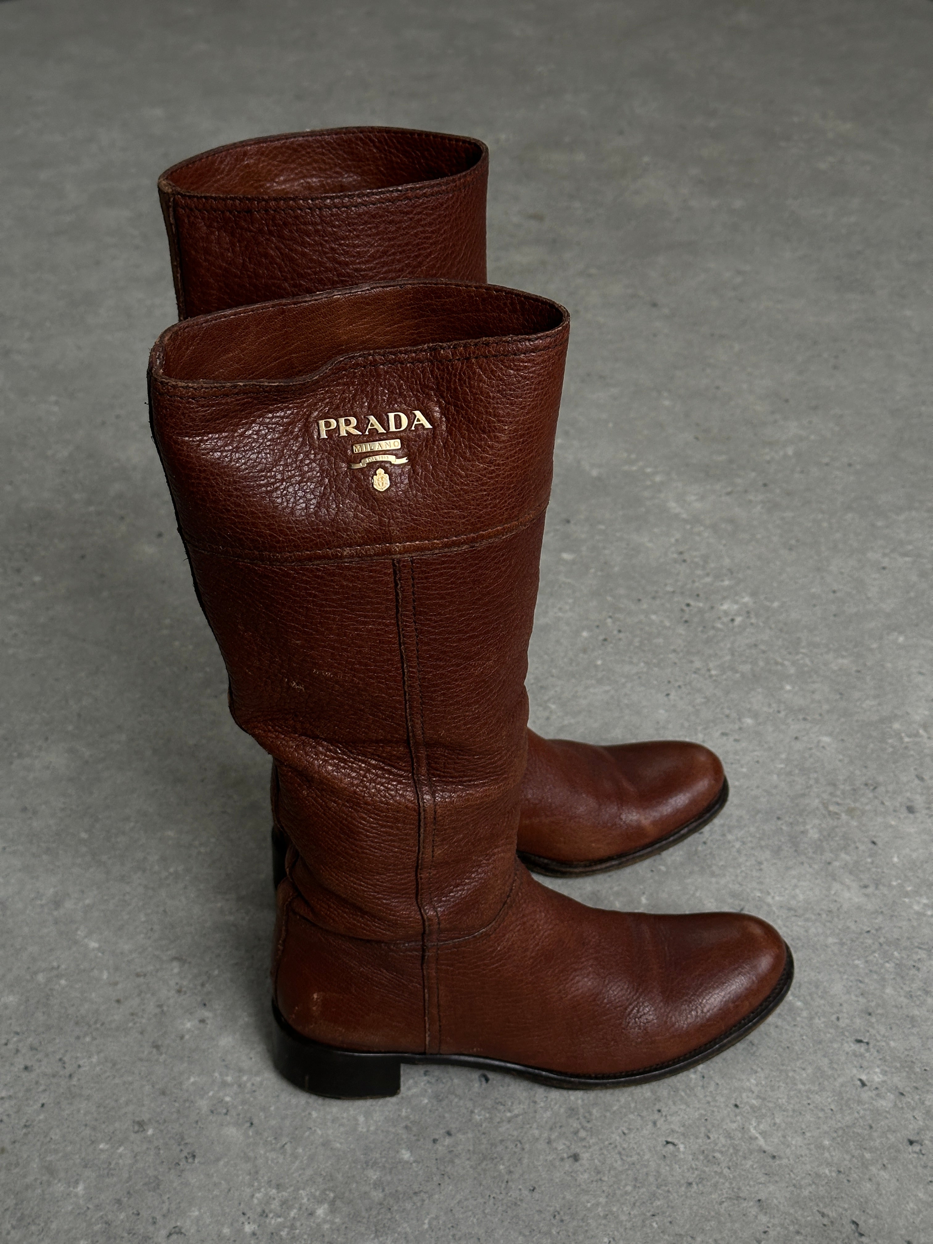 Prada leather logo knee boots in black, UK 4, EUR 37, with sleek design and knee-high length.