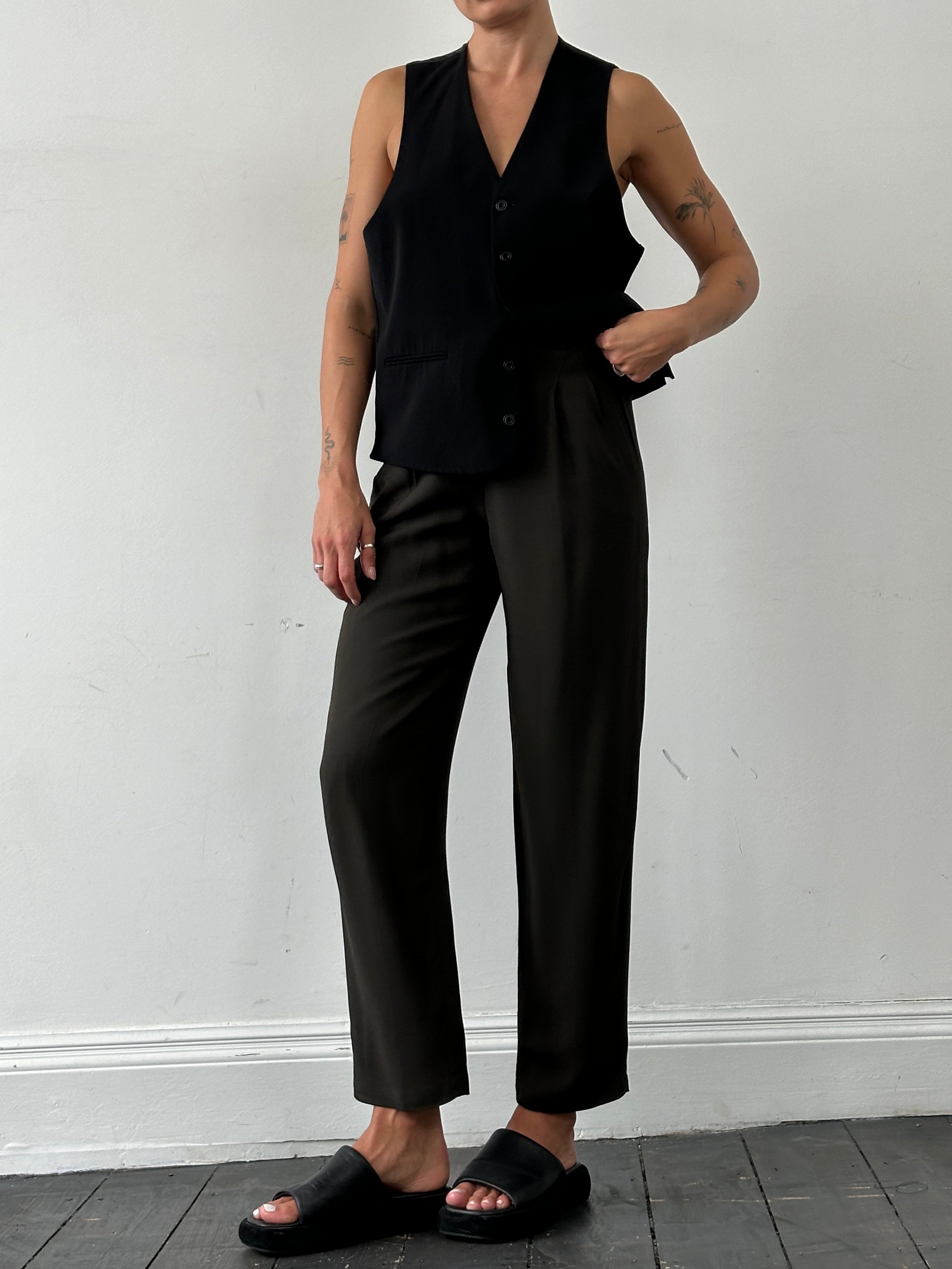 Emporio Armani high waisted tapered leg tailored trousers in dark fabric, front view showing sleek design and tailored fit.