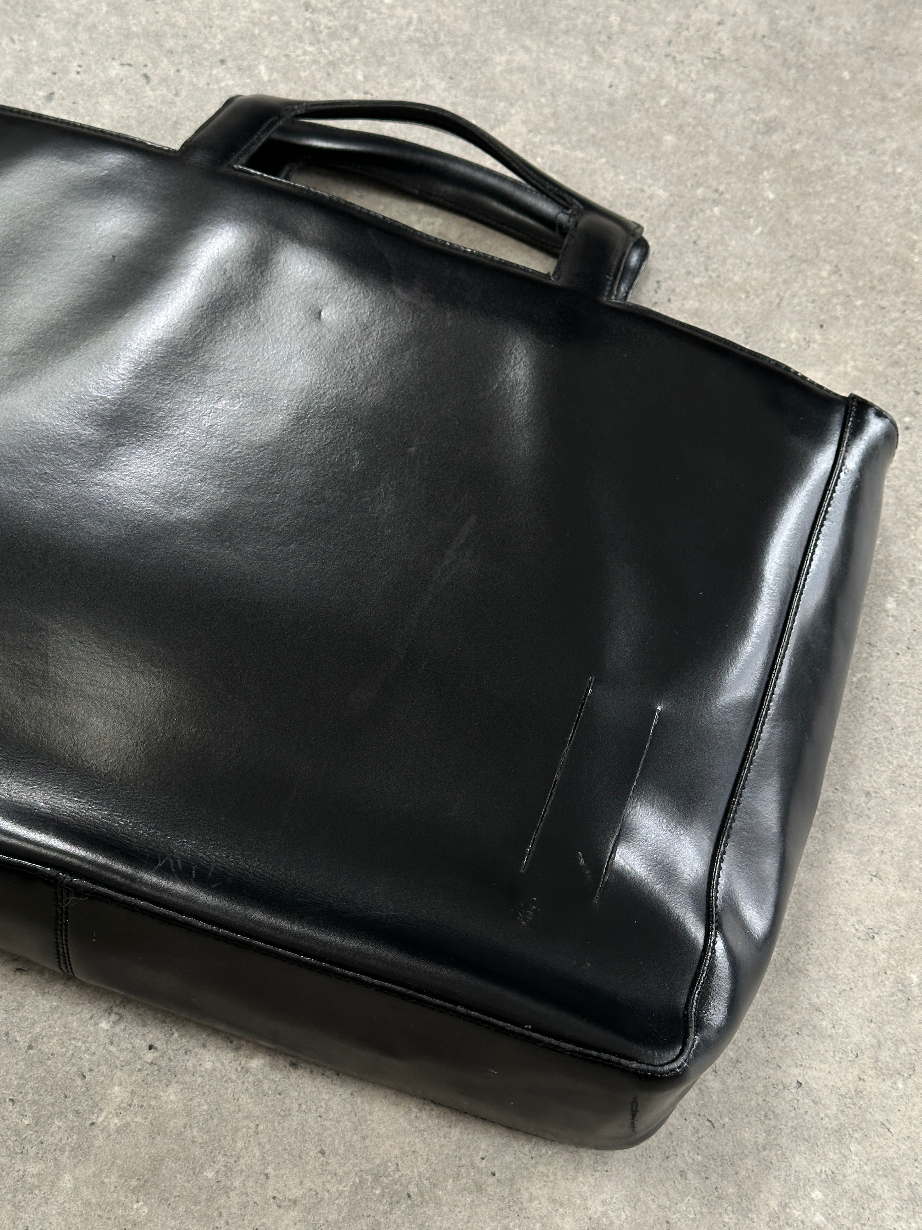 Italian vintage leather briefcase bag with classic design, featuring sturdy handles and brass hardware for a timeless professional look.
