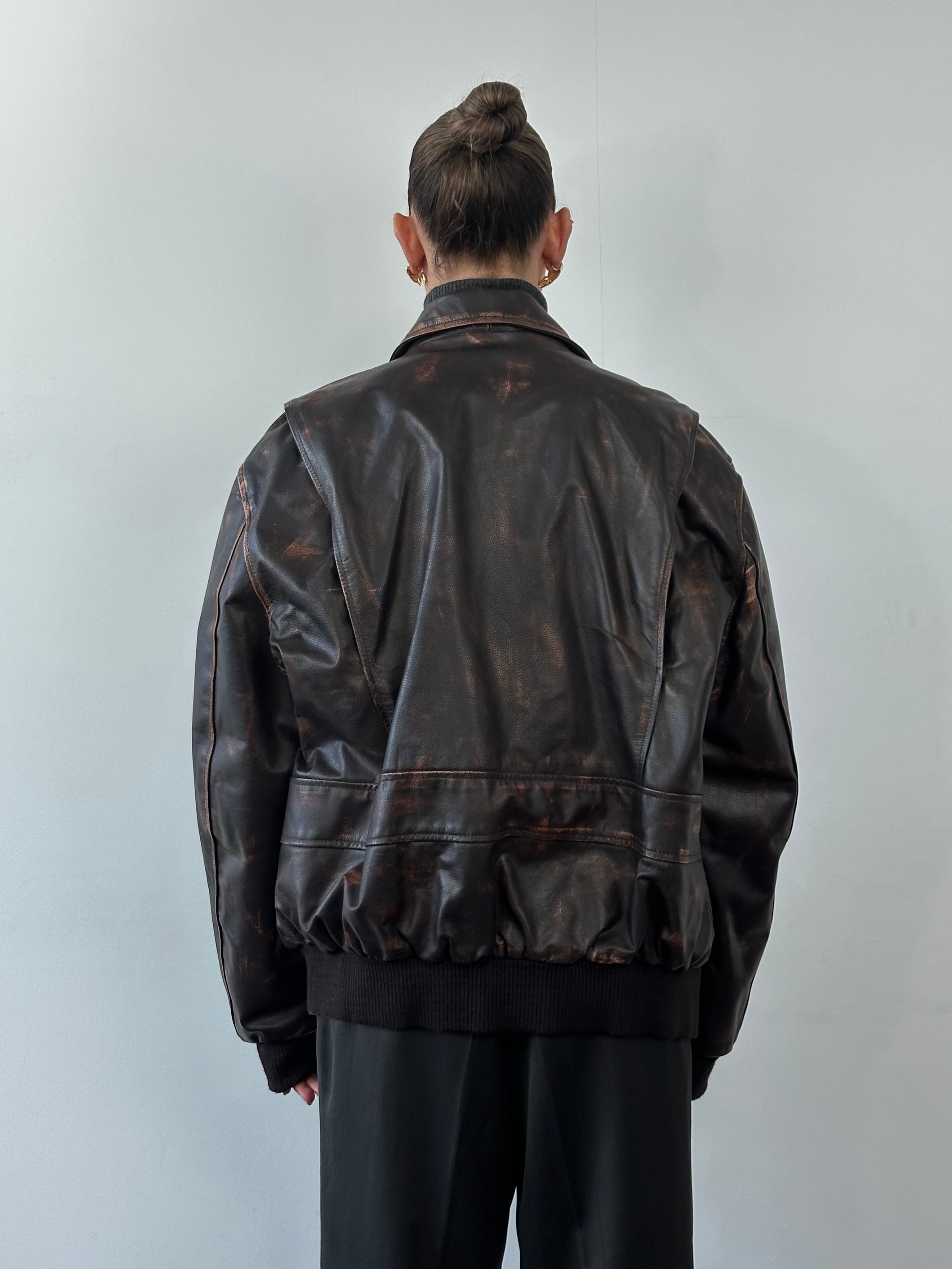 Vintage distressed leather jacket in XL size, featuring rugged style and worn-in texture, perfect for a vintage fashion look.