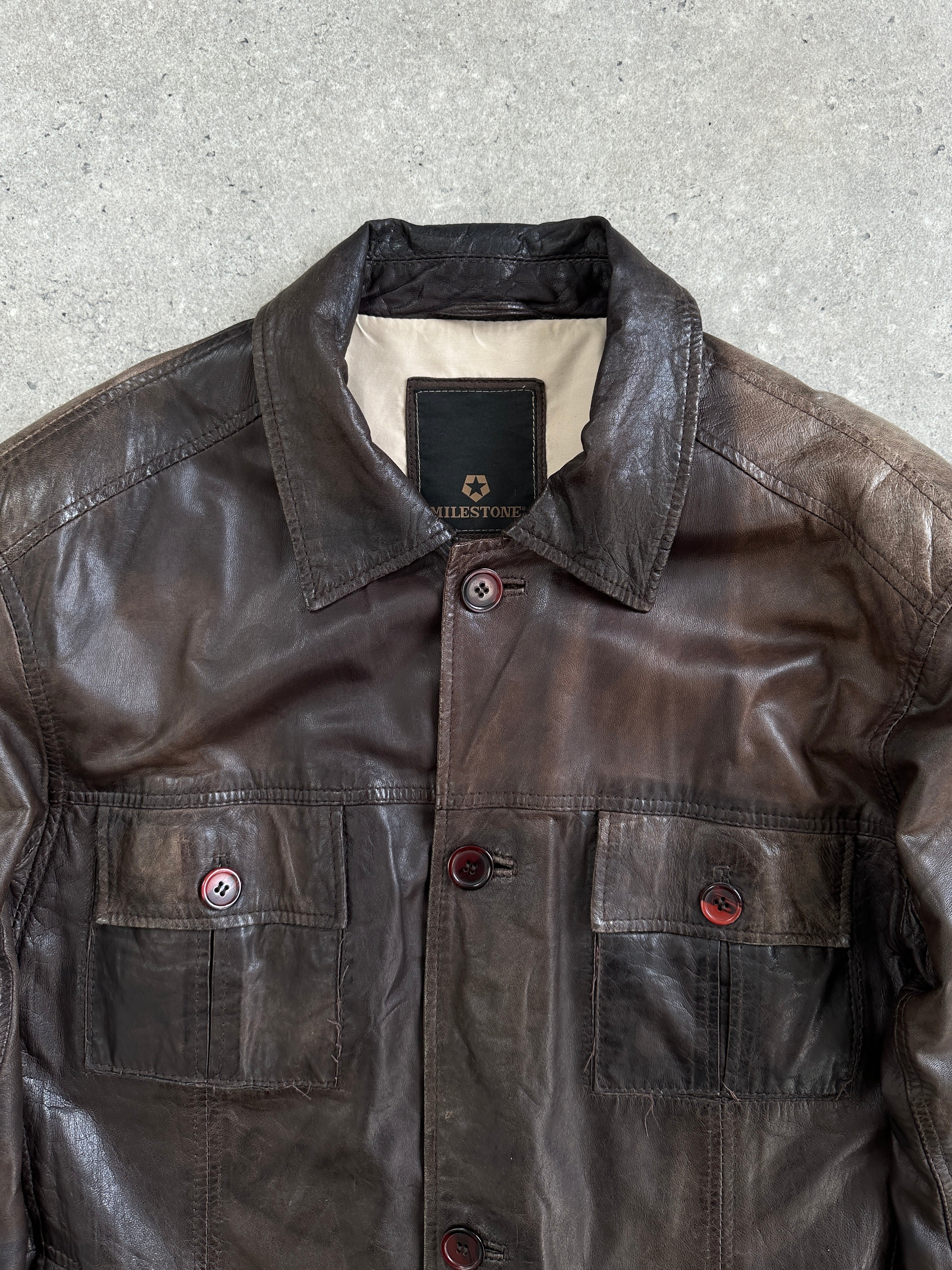Vintage 1990s aged leather jacket in XL, with distressed brown leather and classic style, displayed on a hanger.