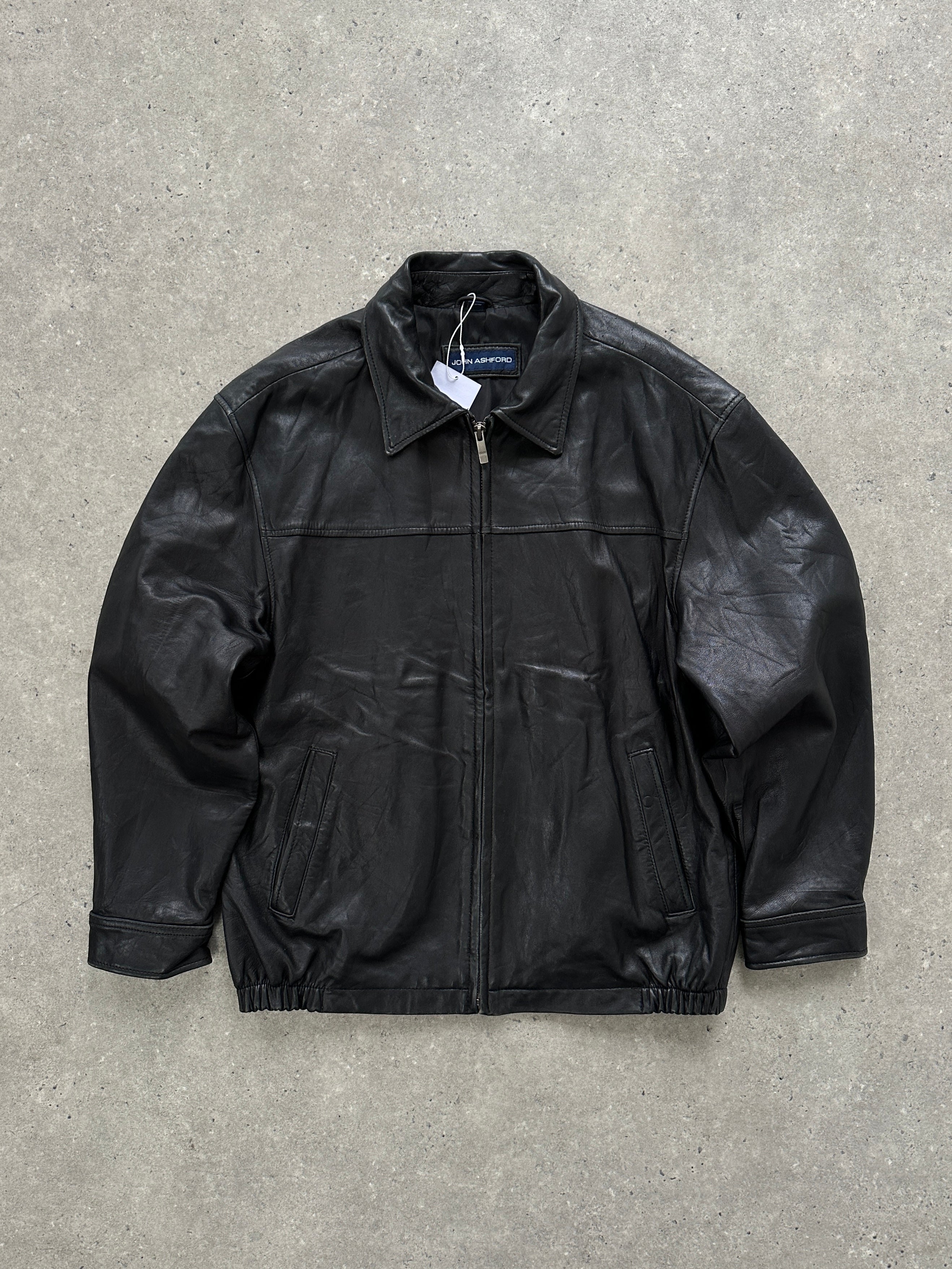 Vintage minimal leather jacket in size L/XL, showcased on a hanger, featuring sleek design and classic leather texture.