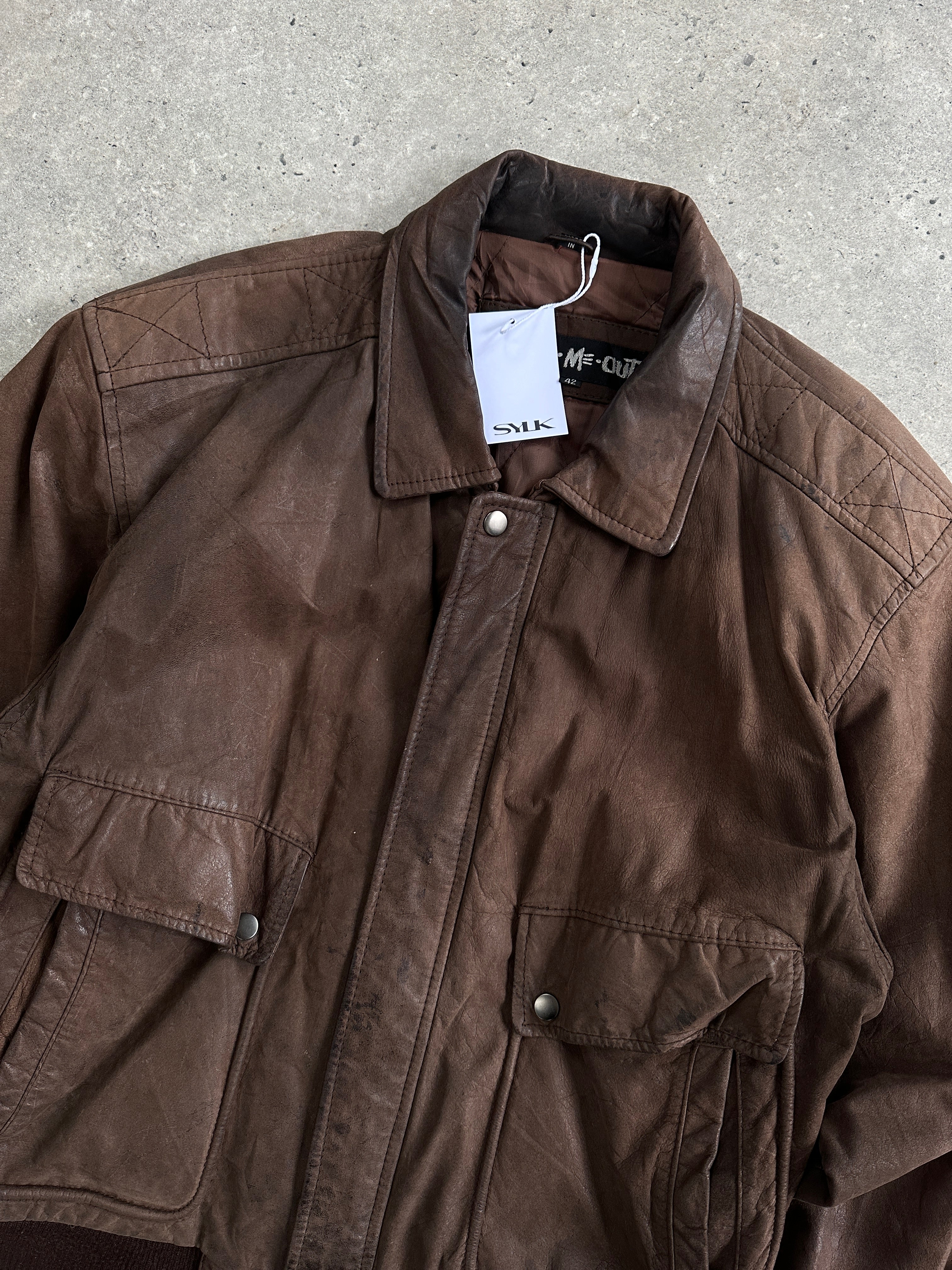 Vintage leather bomber jacket in size large, featuring classic design with ribbed cuffs and collar, worn by a model.