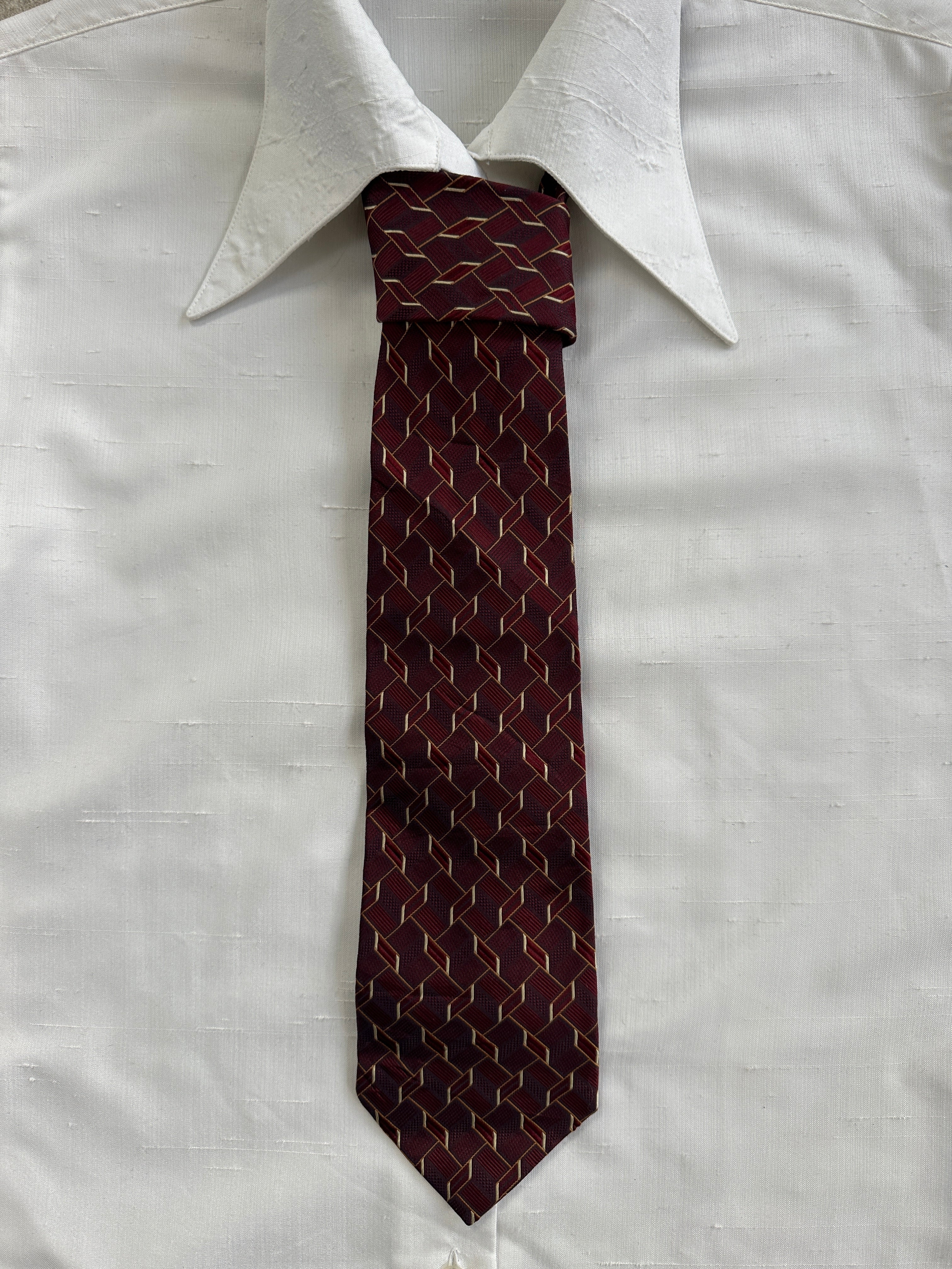 Aquascutum 1990s pure silk tie showing a classic patterned design in deep blue with subtle sheen.