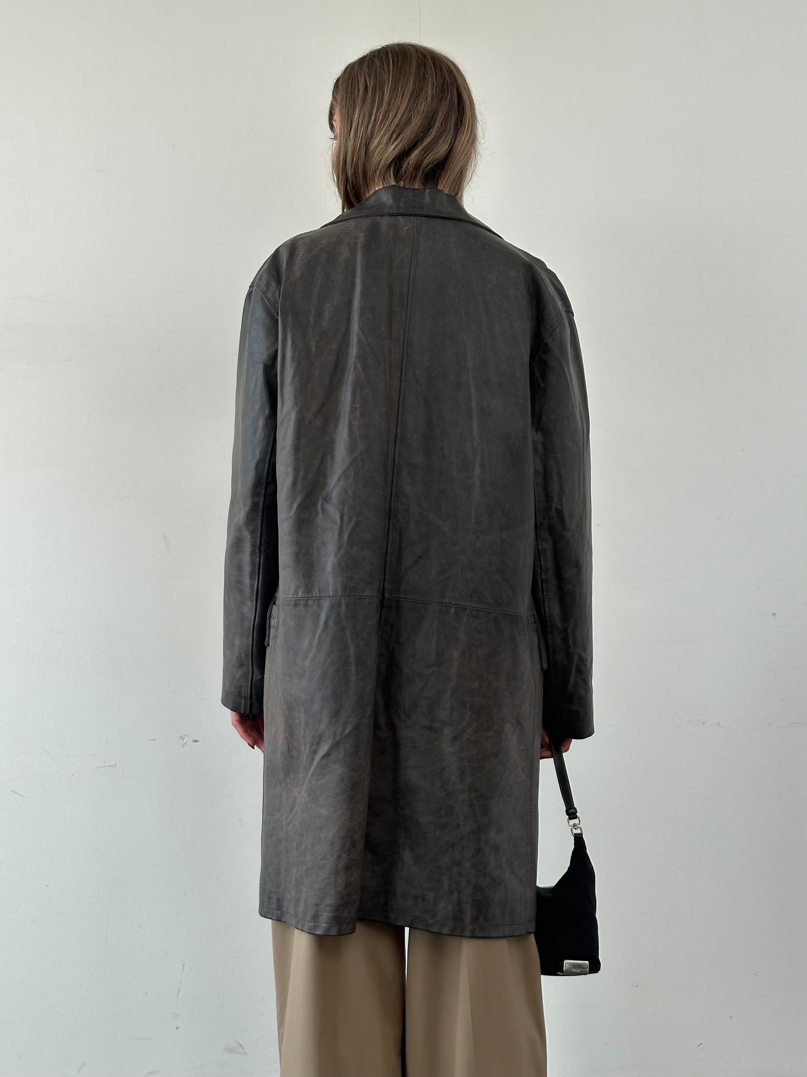 Vintage Italian distressed leather jacket in size L, showcasing worn leather texture and classic design.