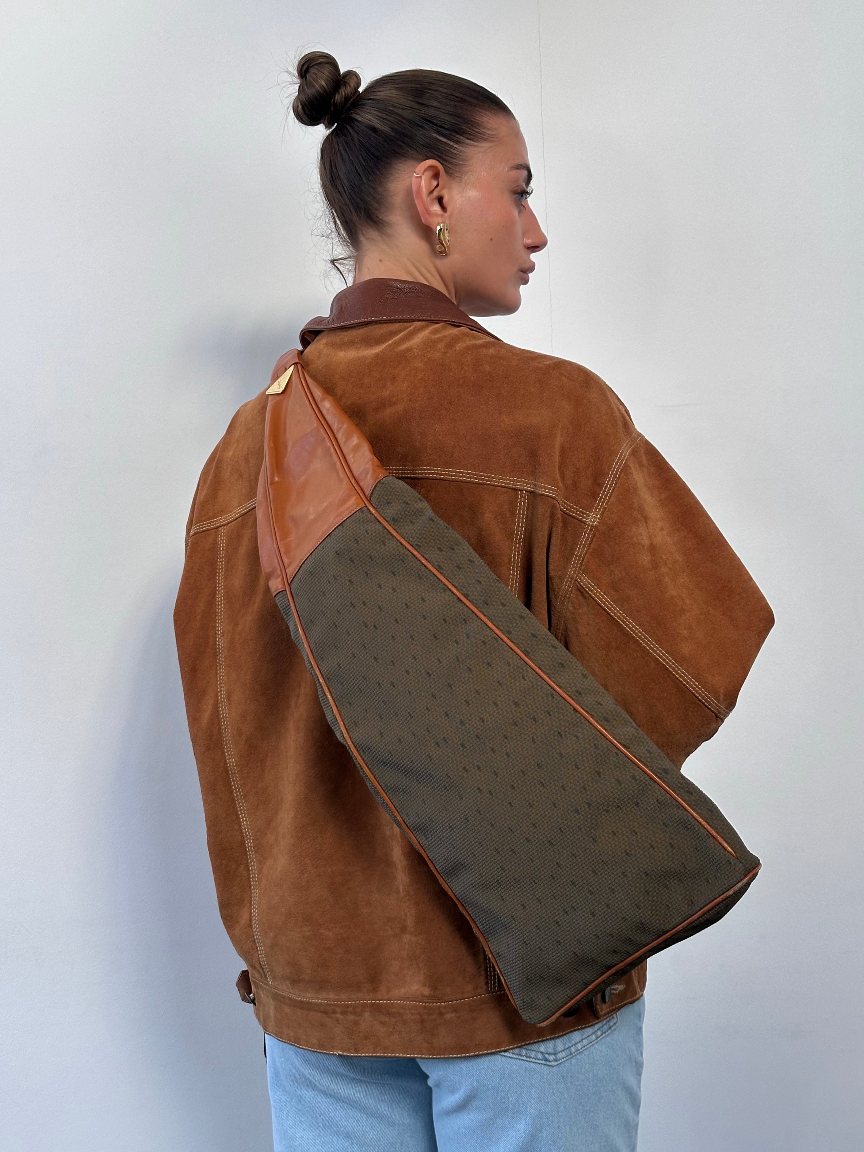 Yves Saint Laurent Paris 80s leather sling bag with sleek design and adjustable strap, featured in the product image.