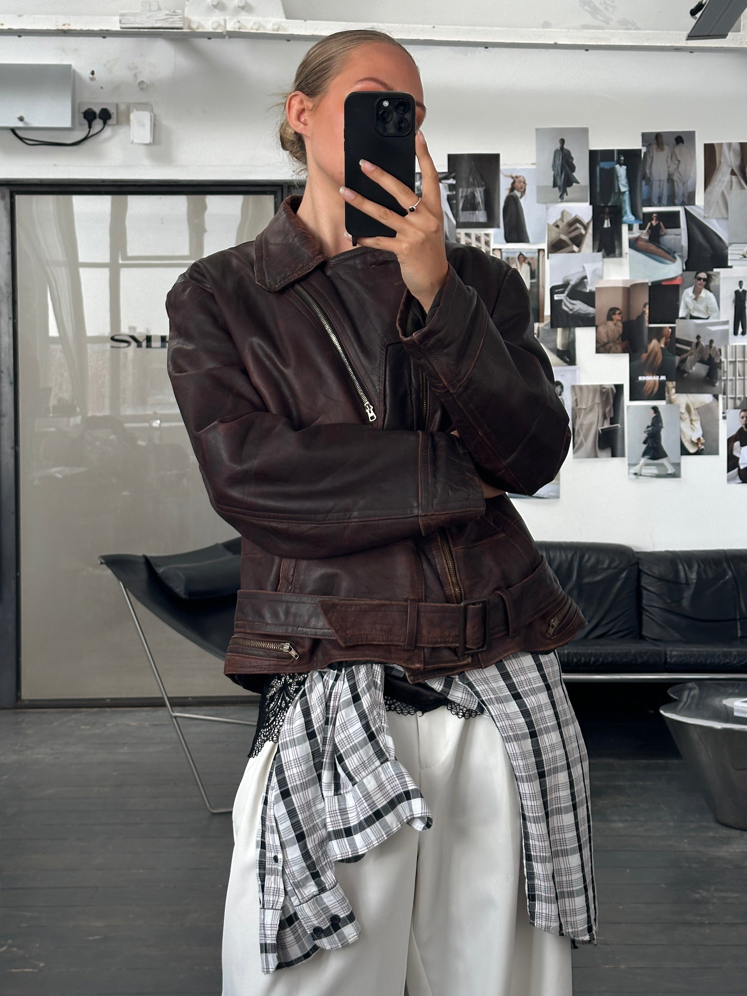 Vintage 1980s distressed leather biker jacket, large/extra-large size, featuring rugged design and classic motorcycle style.