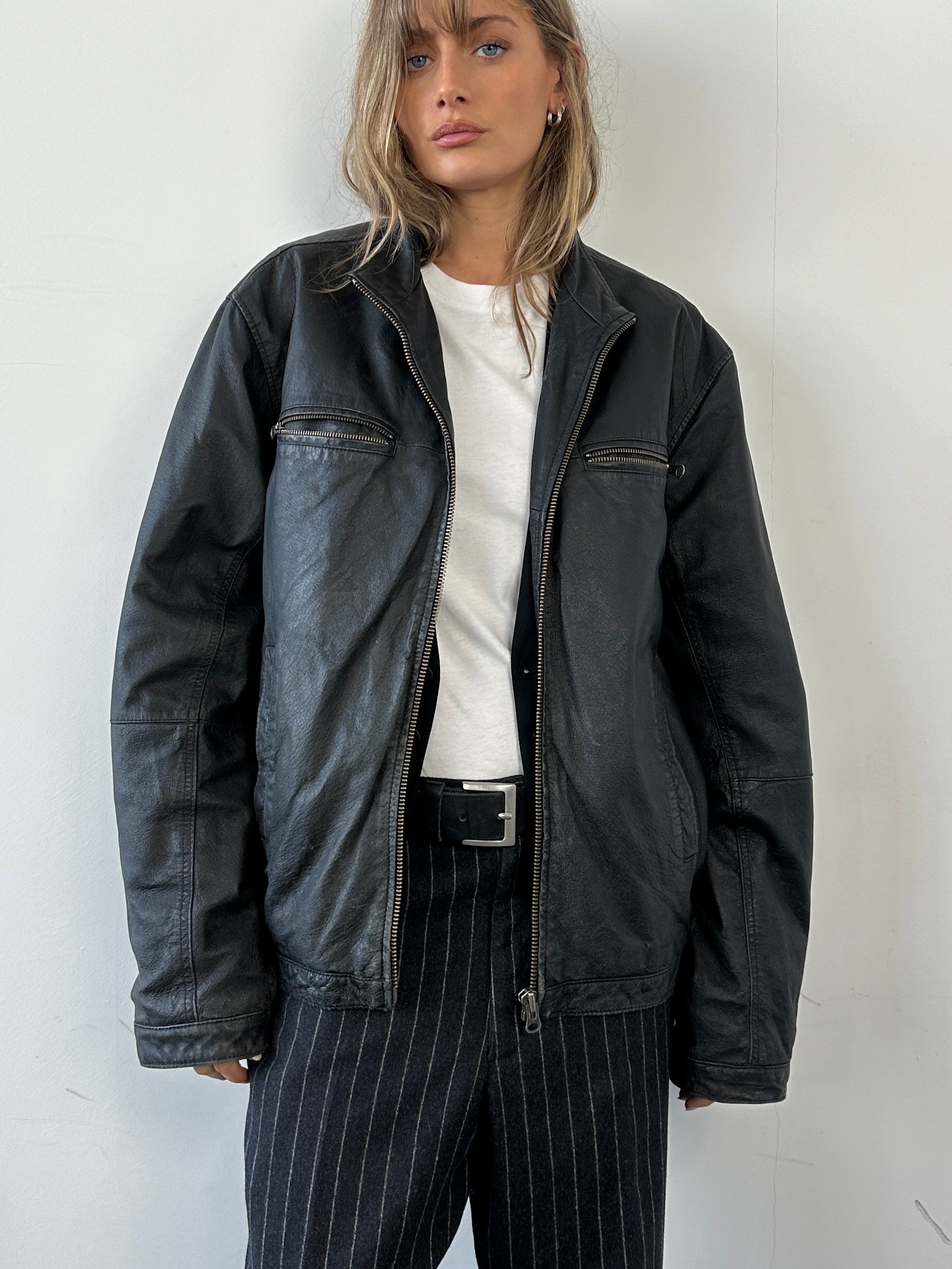 Vintage leather zip-up jacket in size large, featuring a classic design with a smooth leather finish and stylish collar.