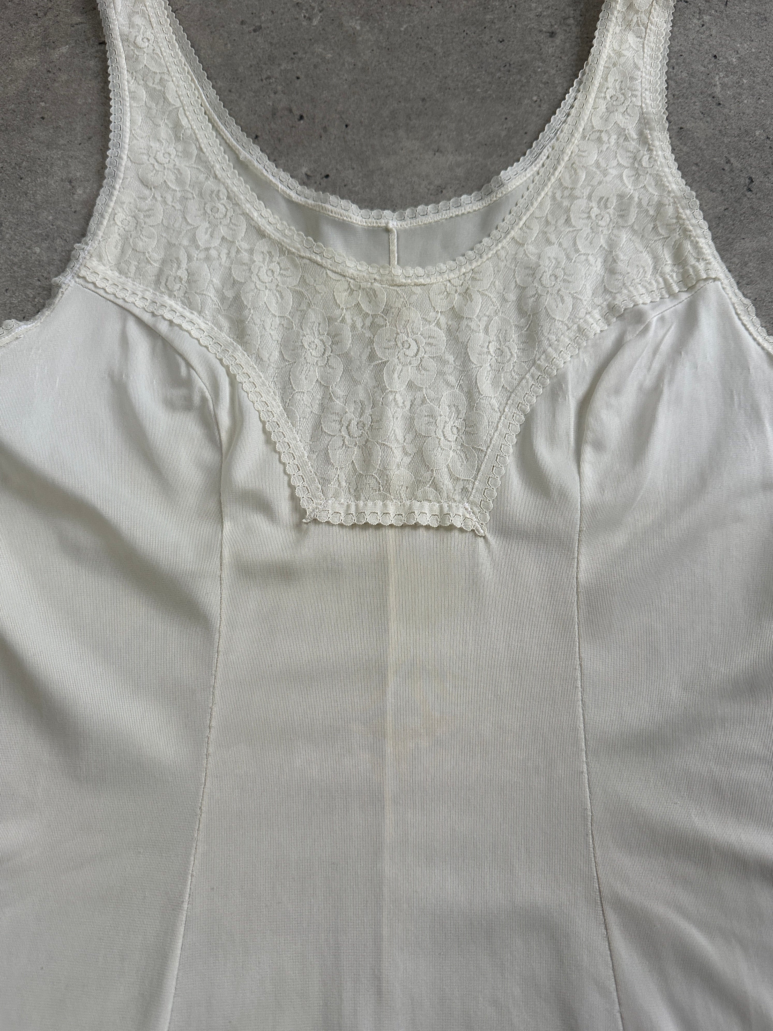 Vintage 1990s lace mini slip dress in size small, featuring delicate lace fabric and a fitted silhouette.