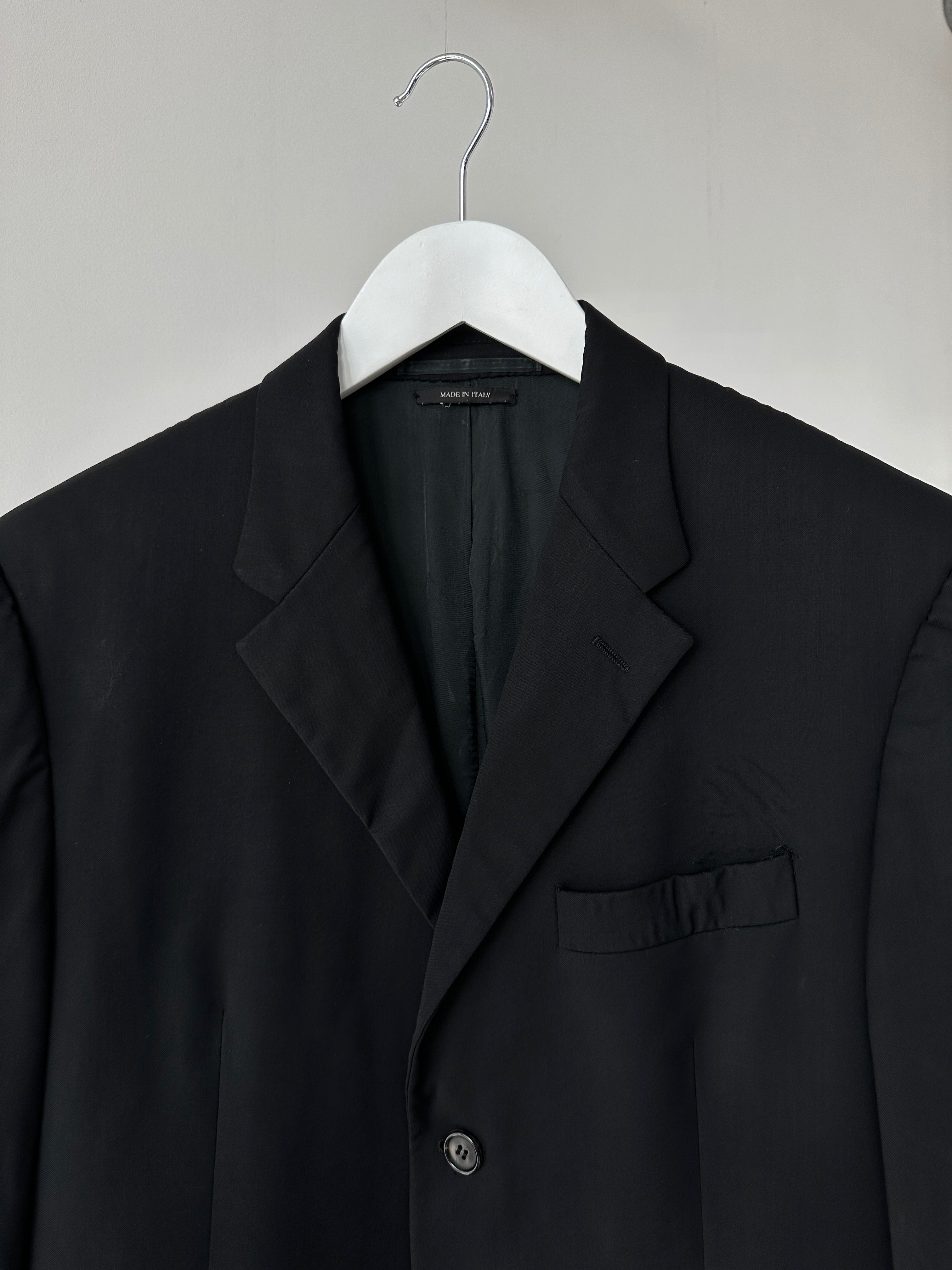 Prada virgin wool jumpsuit in mid-rise, single-breasted style, featuring a tailored fit and classic design.