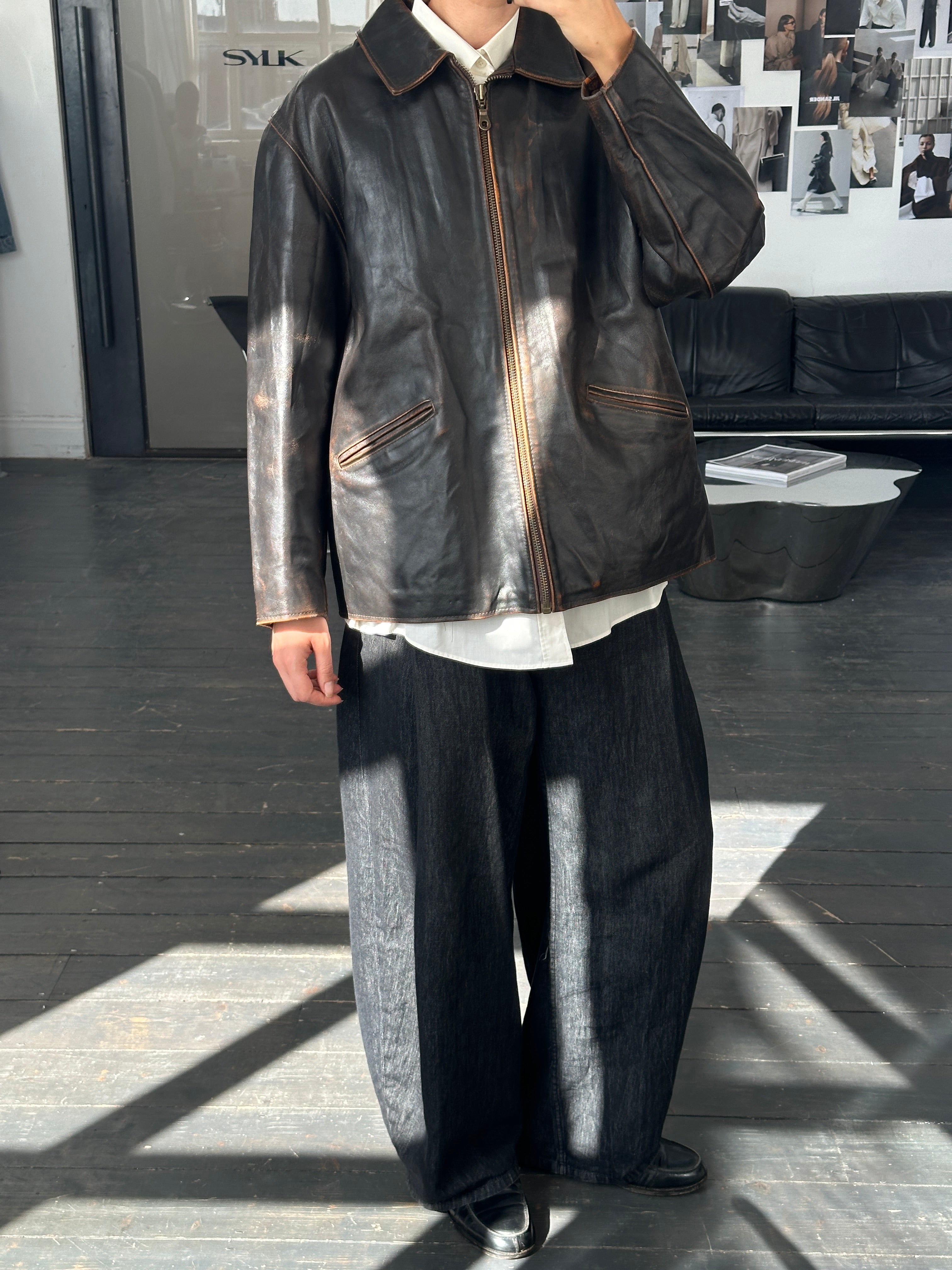 Vintage Italian 1990s distressed leather jacket in large/extra-large size, showcasing rugged, worn-in leather and classic style.