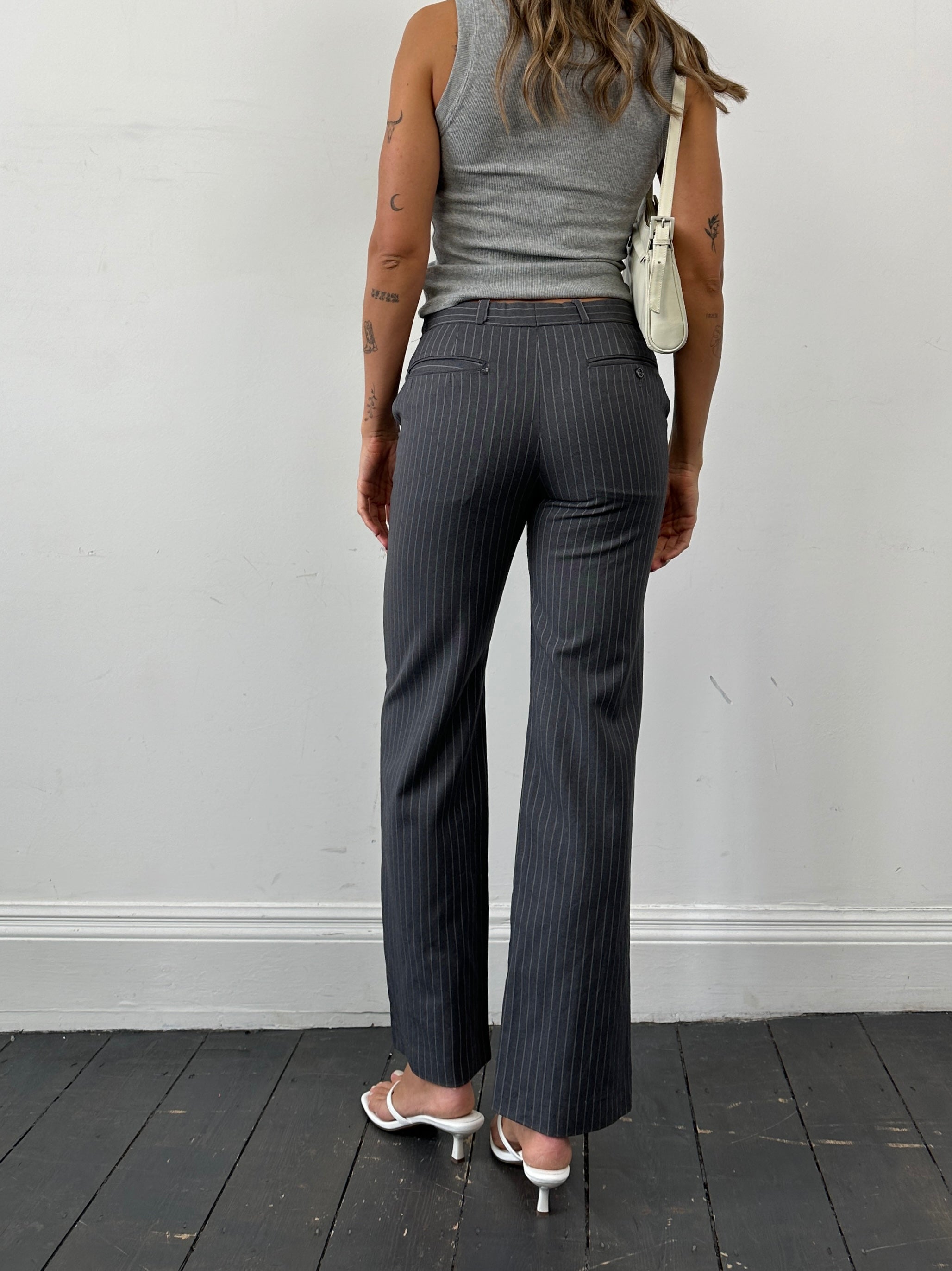 Christian Dior pinstripe wool mid-waist straight-leg trousers, size W30, with tailored fit and classic pinstripe pattern.