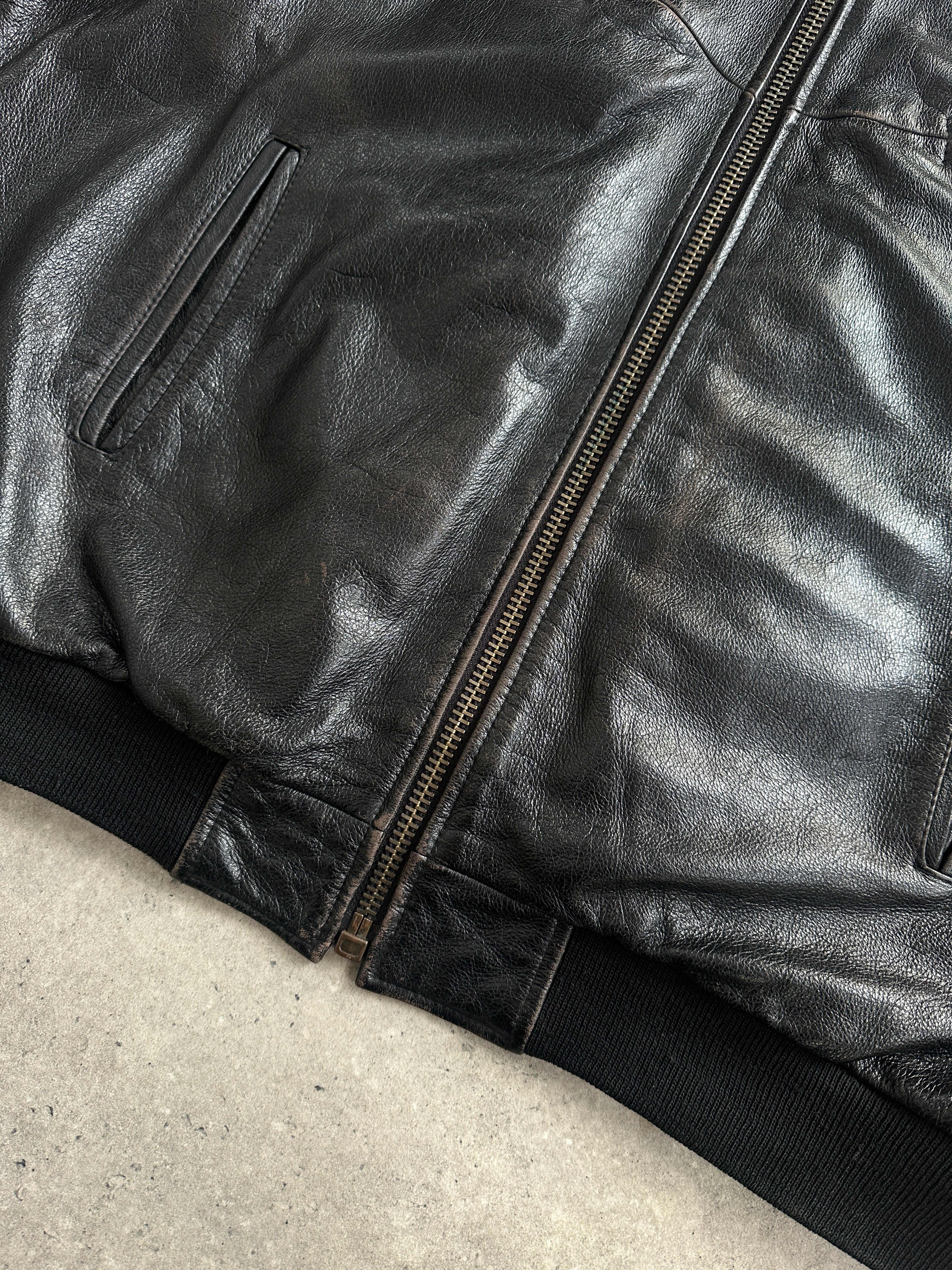 Vintage BMW 1990s leather bomber jacket in XL with classic design, featuring a smooth leather exterior and ribbed collar.