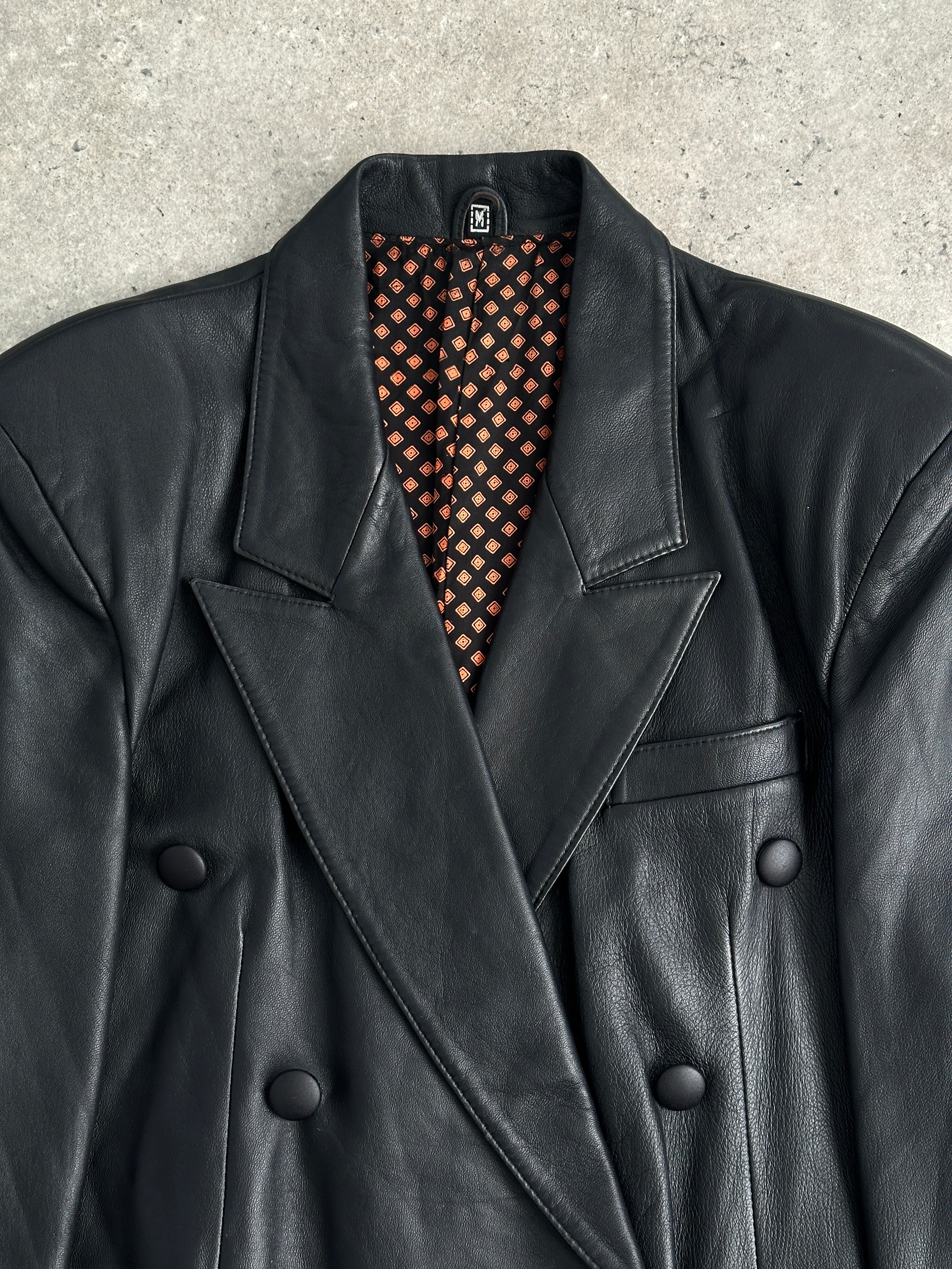 Vintage double-breasted leather blazer jacket in size large, featuring classic design and rich brown leather detail.