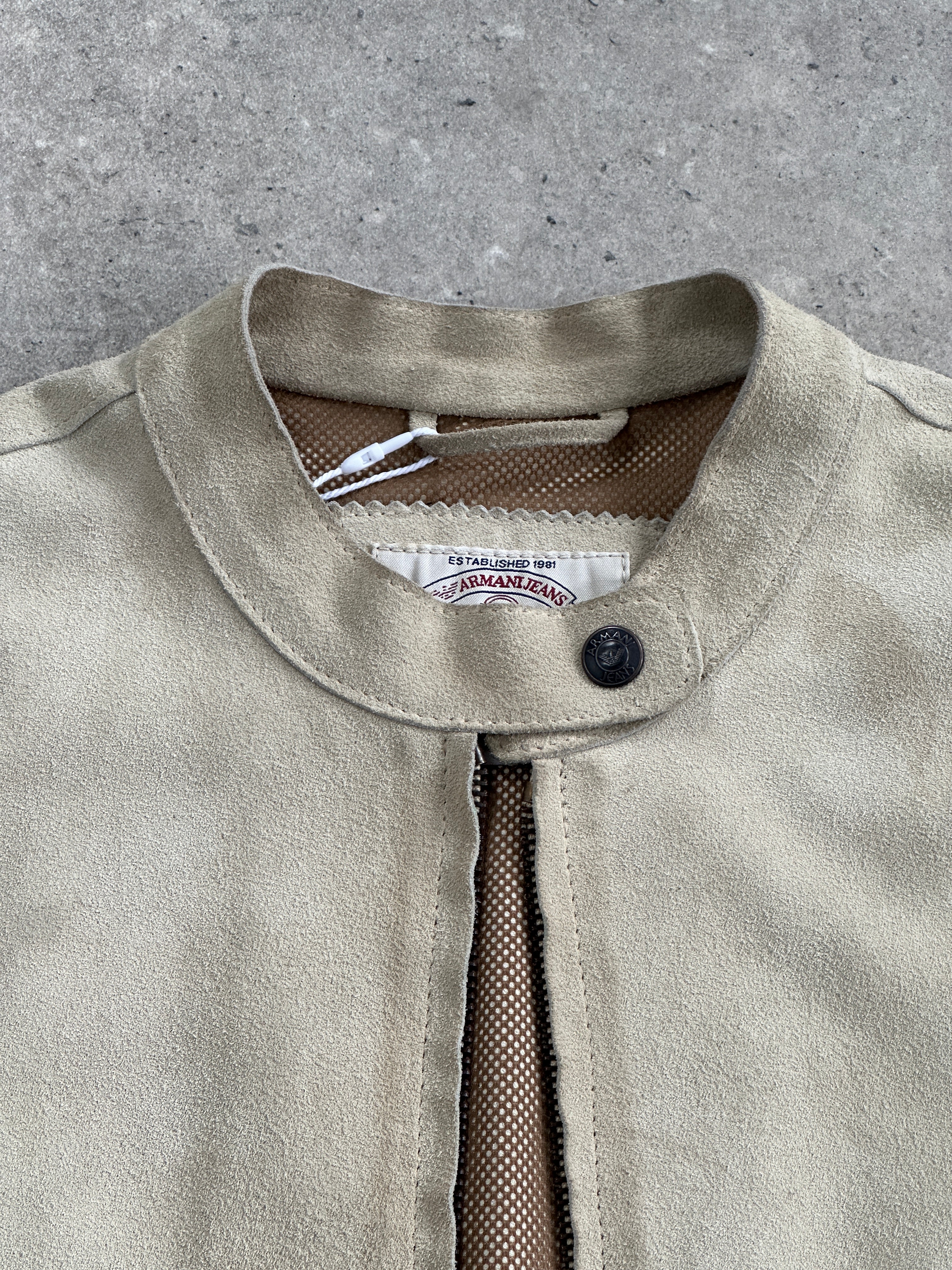 Armani Jeans fitted suede jacket in XS/S, shown in a close-up image highlighting the soft texture and stylish design.