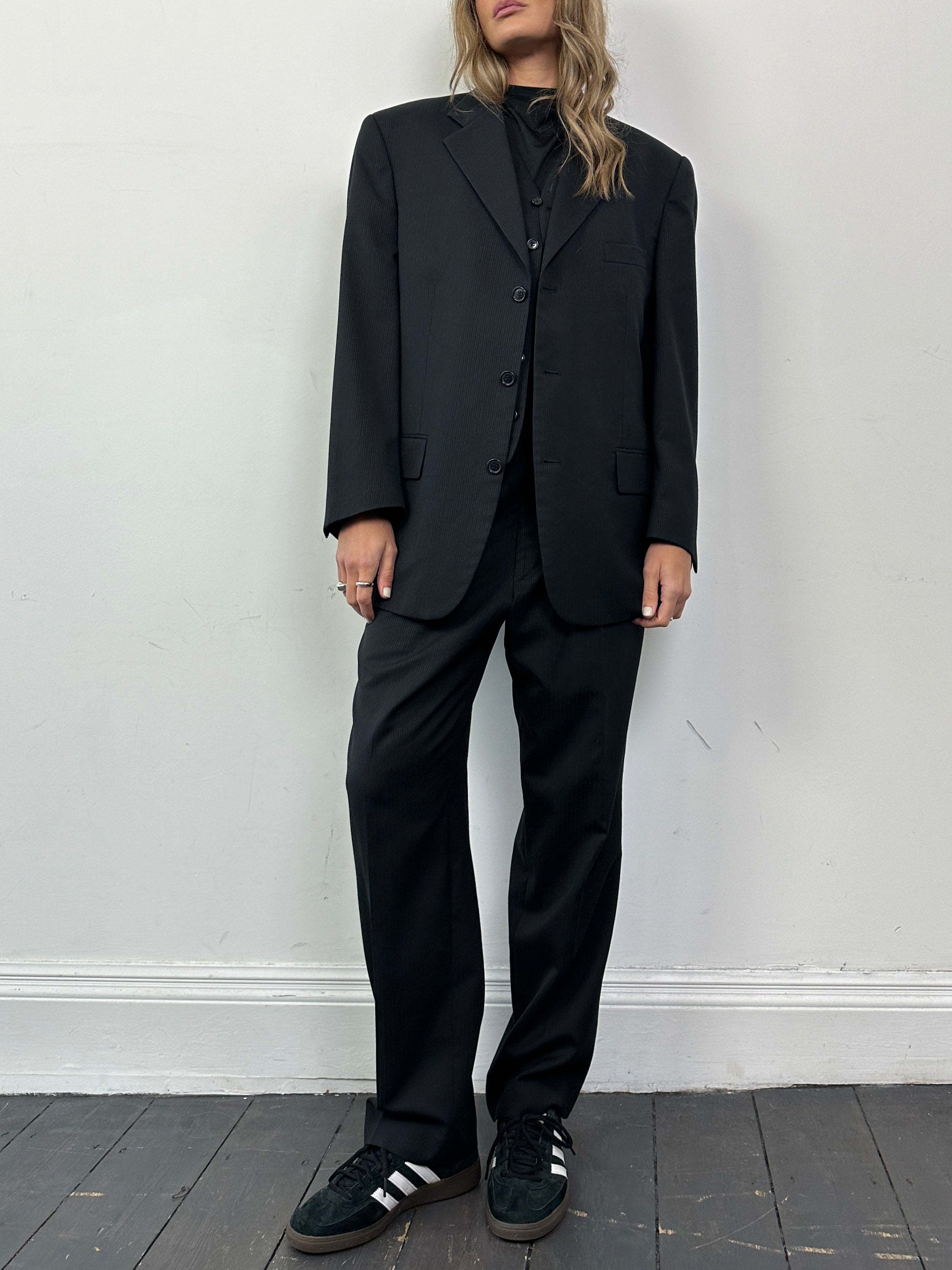 Vintage wool ribbed three-piece suit with tailored jacket, vest, and trousers in classic style, suitable for formal occasions.
