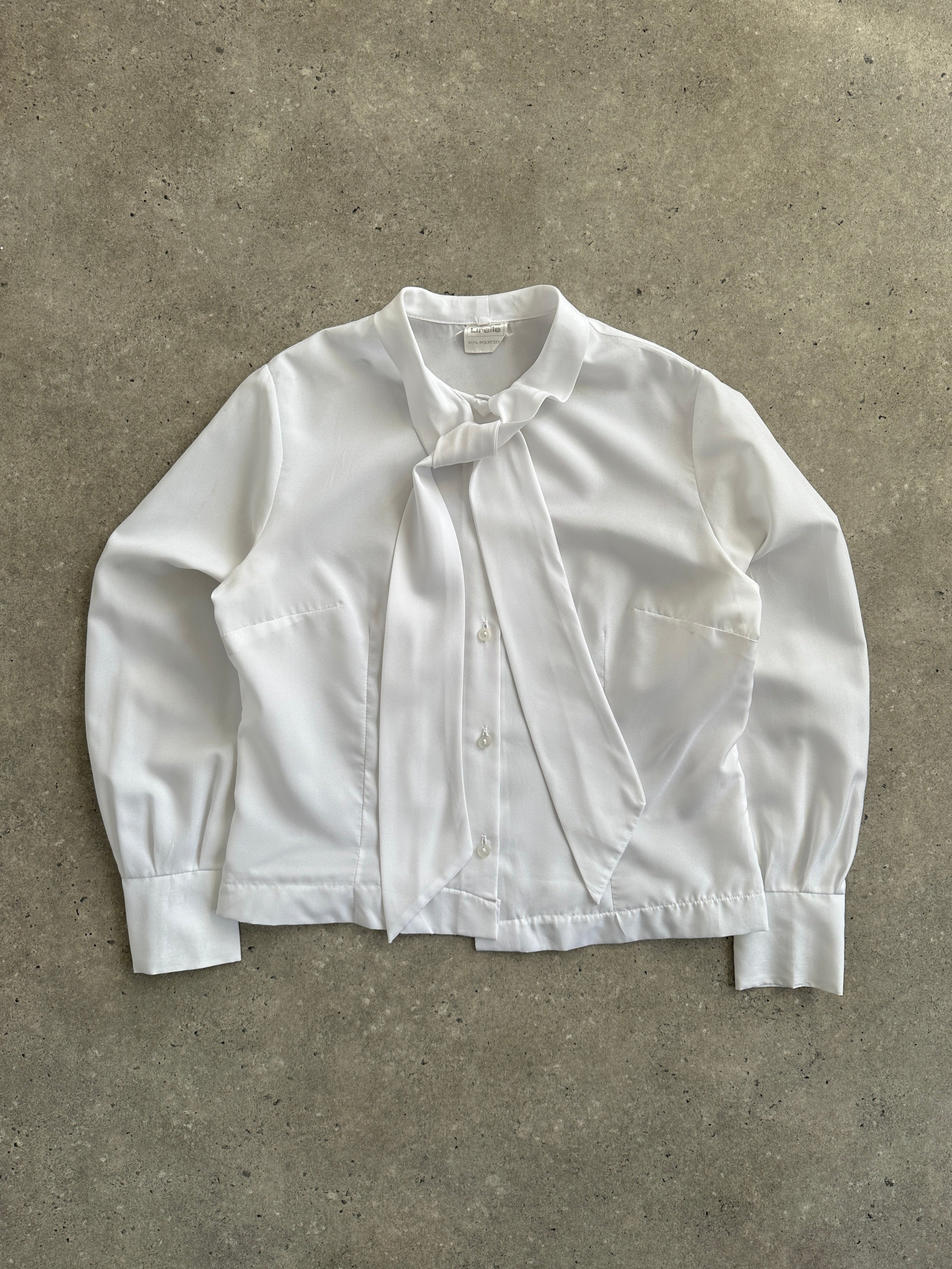 Vintage 1980s neck tie shirt in size S/M, featuring retro pattern and classic button-up design, displayed on a hanger.