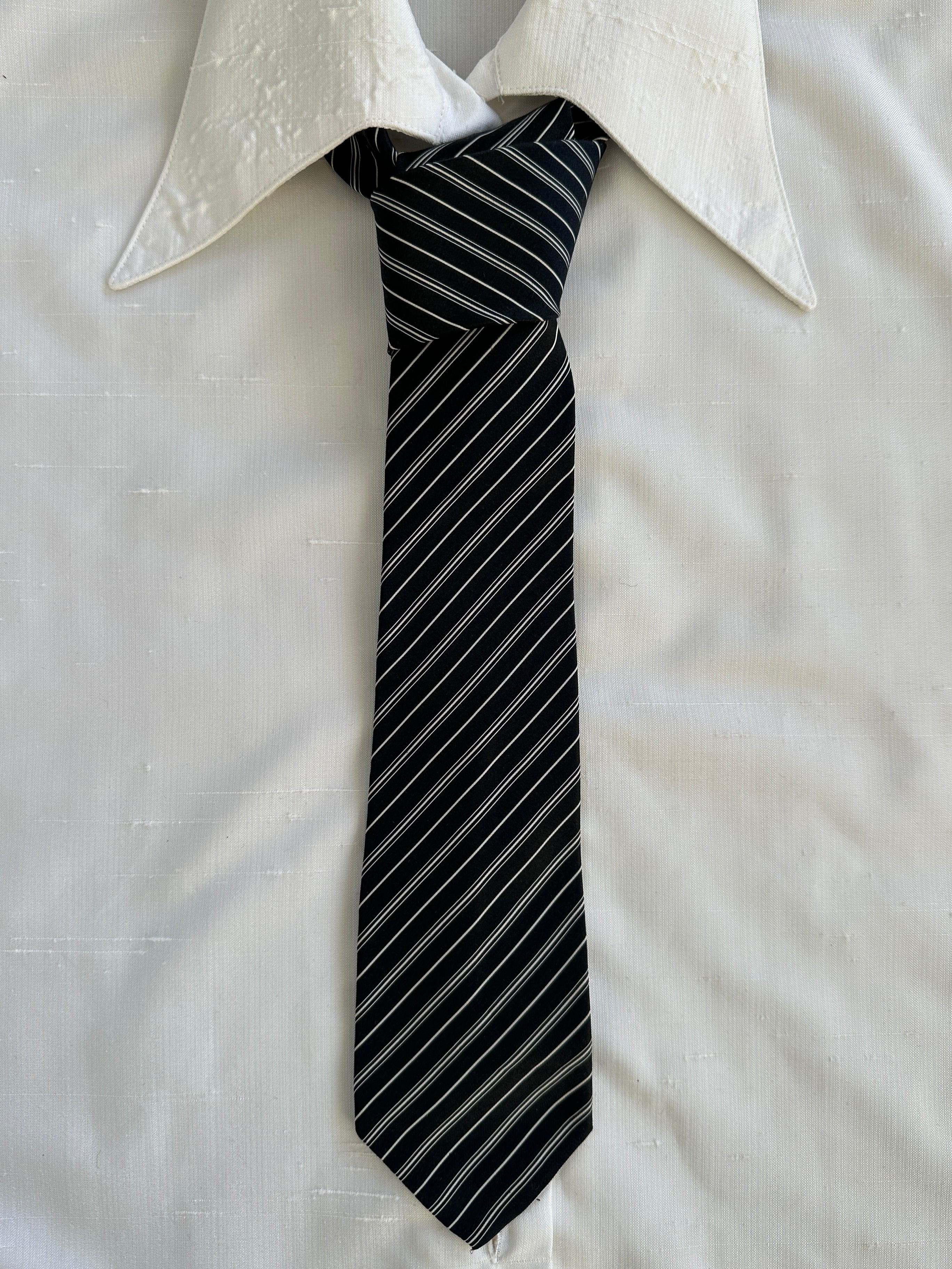 Vintage 1990s pure silk striped tie featuring classic blue and gray pattern, showcasing elegant craftsmanship and timeless style.