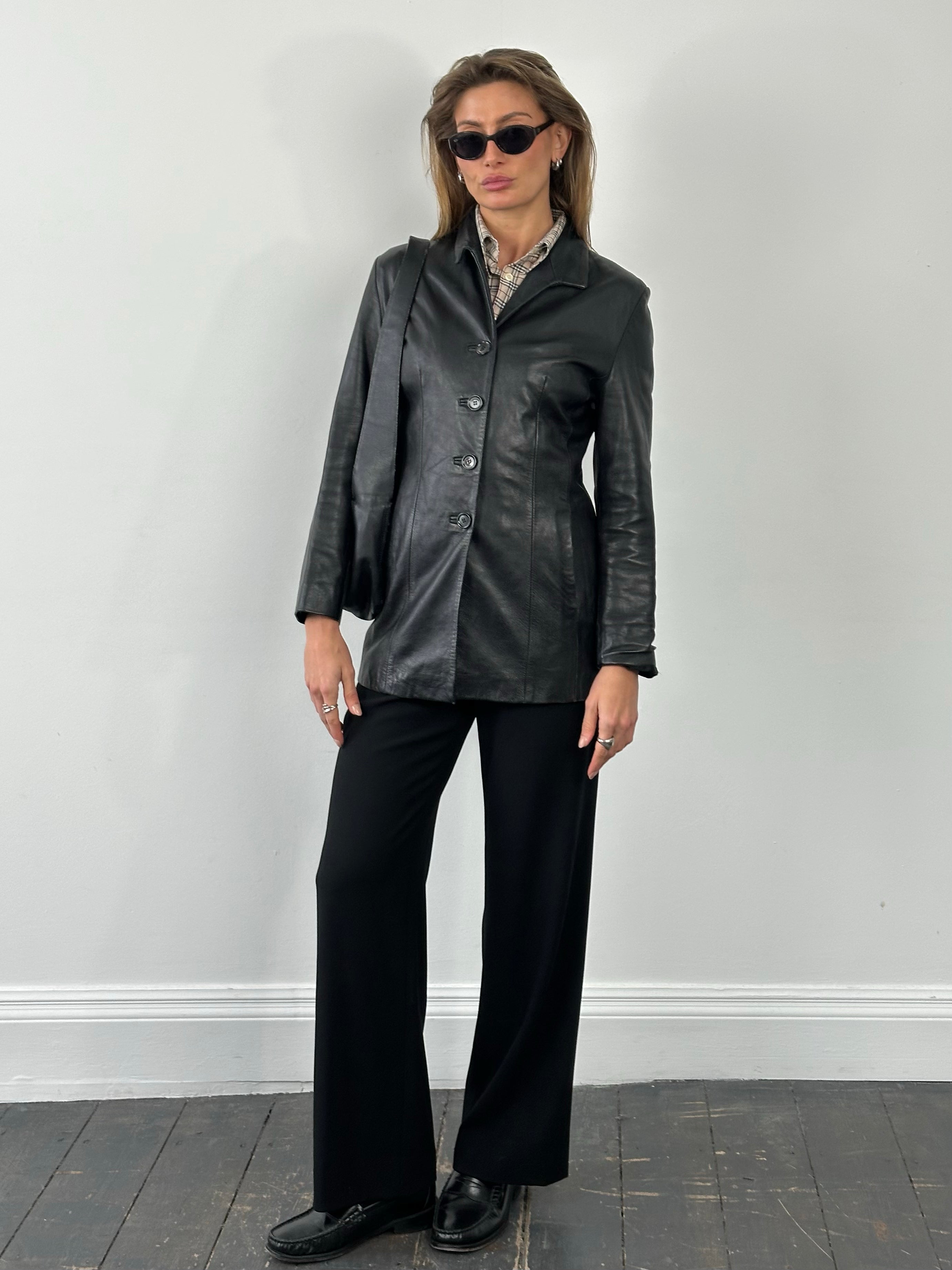 Vintage British 1990s fitted leather jacket, size small, with classic style and detailed stitching.