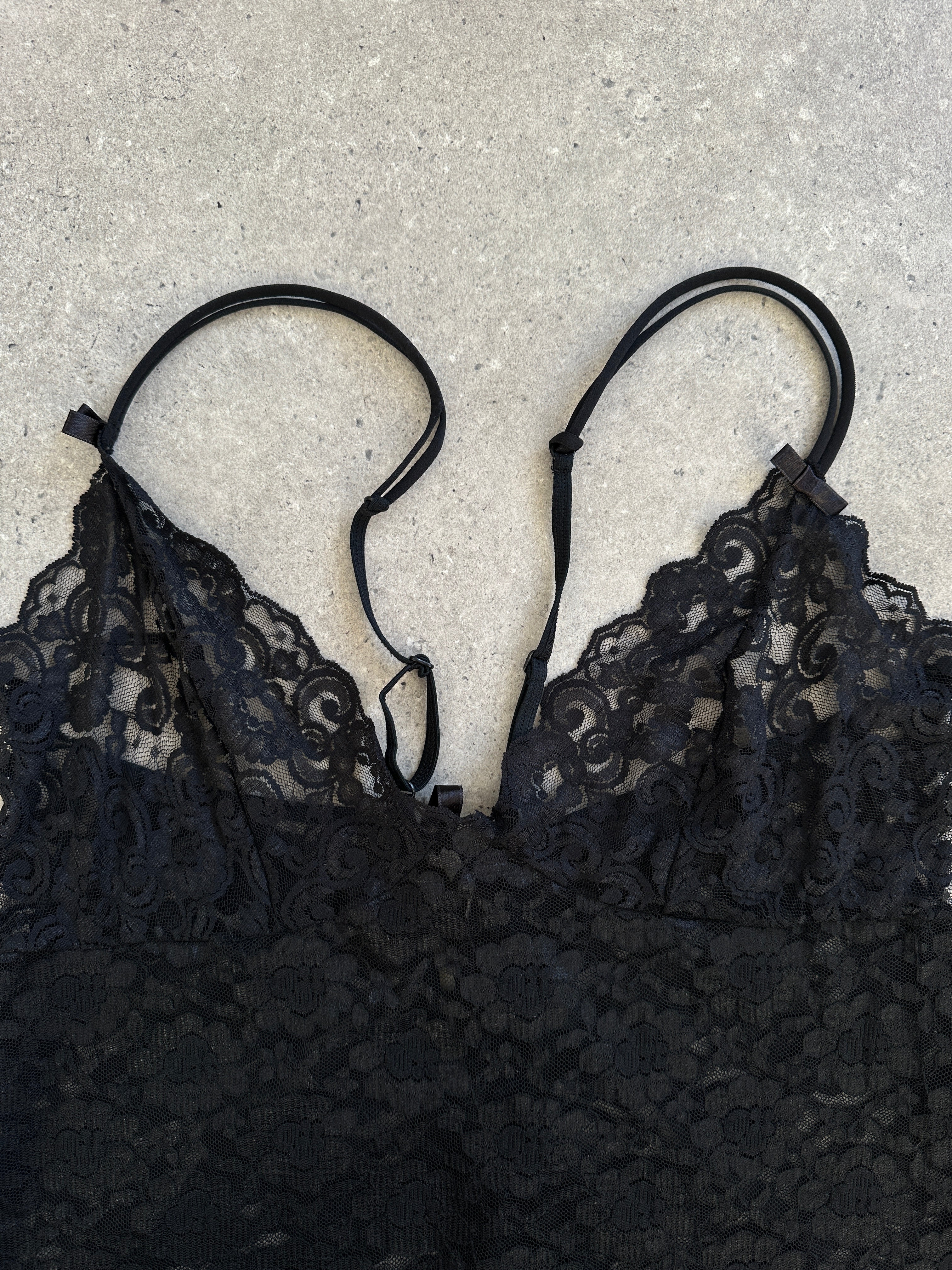 Vintage 1990s sheer lace mini slip dress in size large, featuring delicate lace details and a classic 90s style.