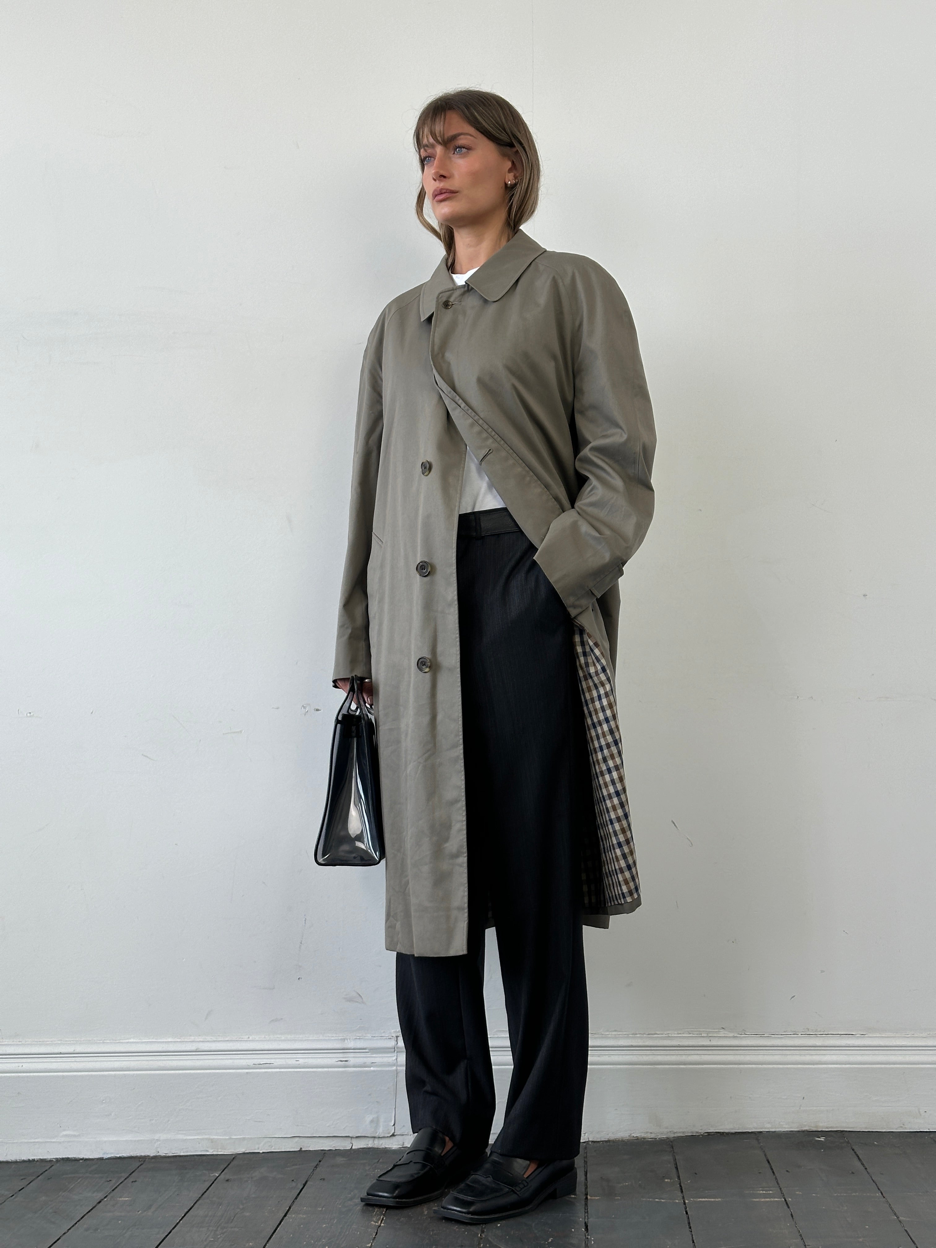 Aquascutum cotton trench coat with concealed placket in XL size, classic beige color, tailored fit, and waterproof fabric.