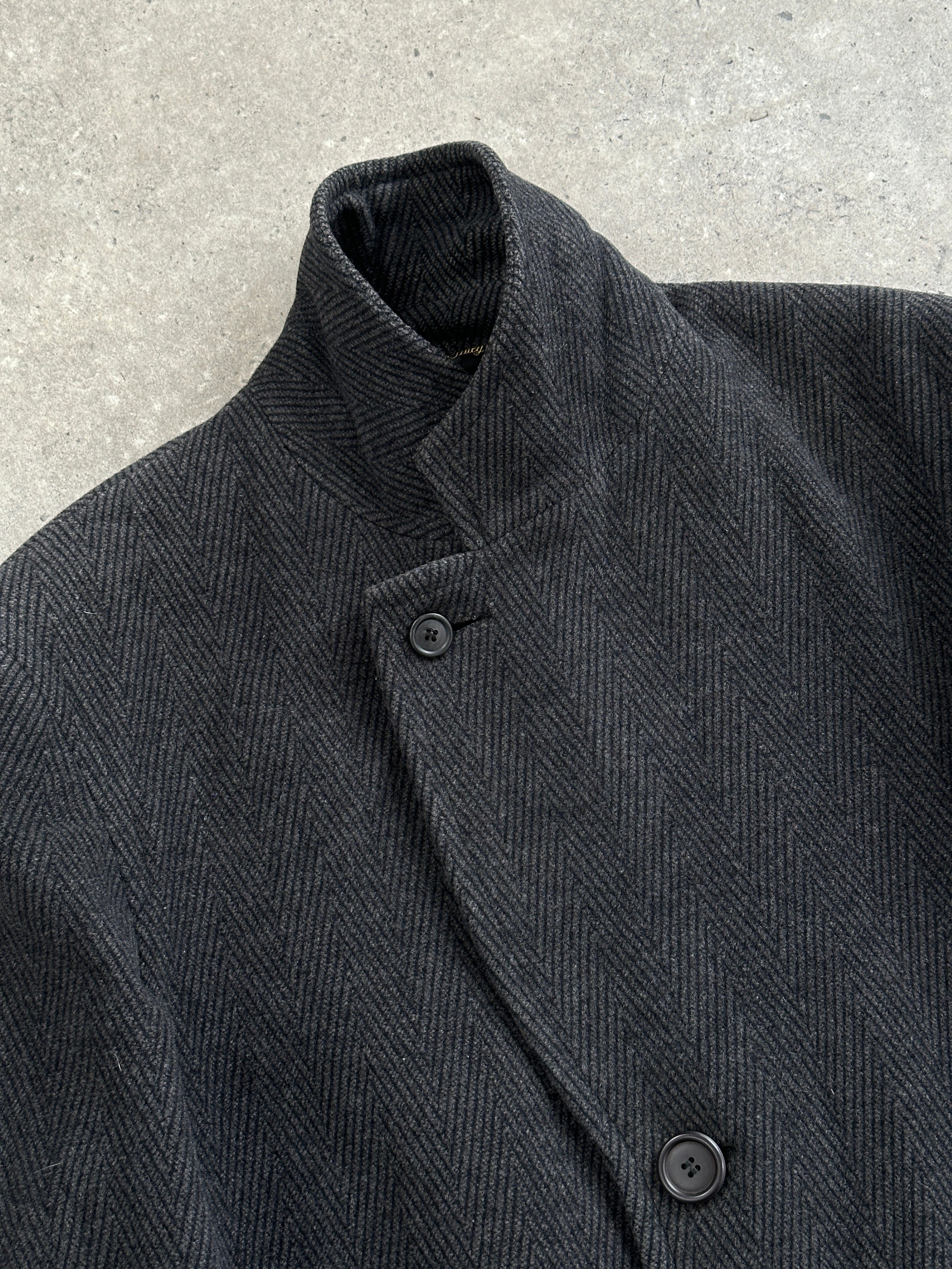 Vintage Italian 1980s wool cashmere herringbone coat in XL, featuring classic pattern and tailored fit, displayed on a hanger.