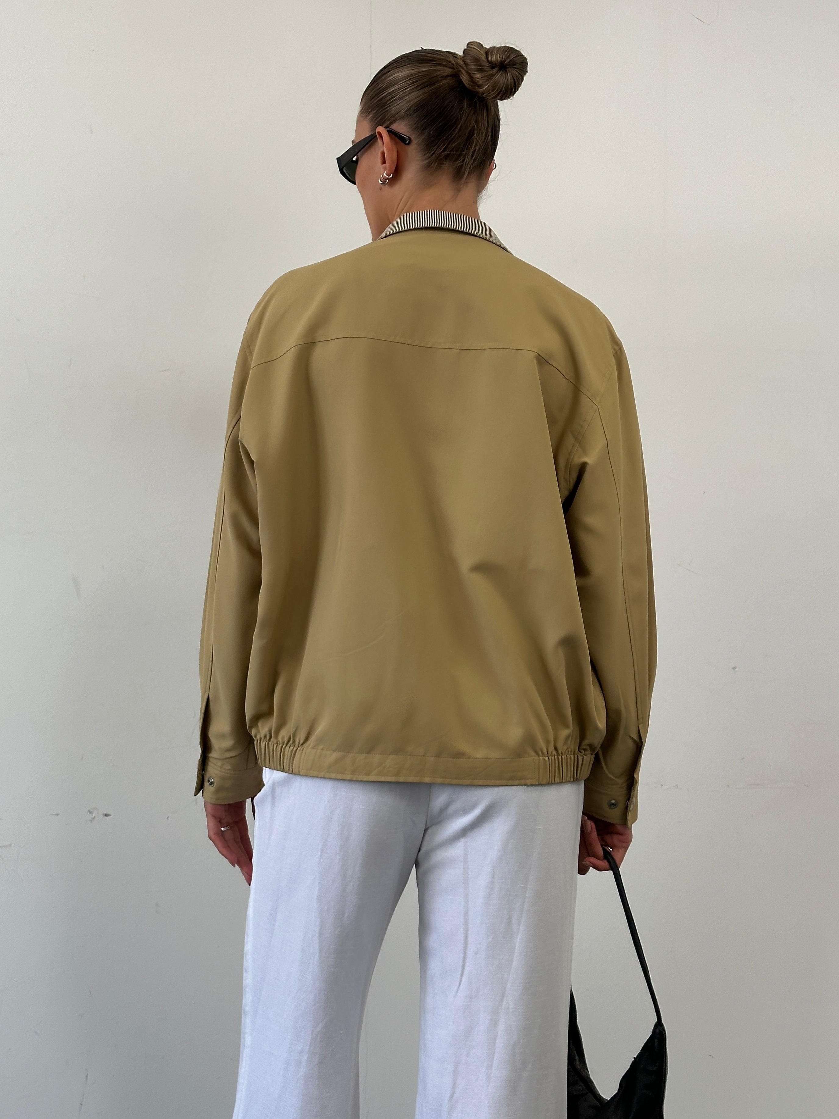 Yves Saint Laurent logo bomber jacket in black, size M/L, featuring the iconic YSL logo on the front and stylish ribbed cuffs.