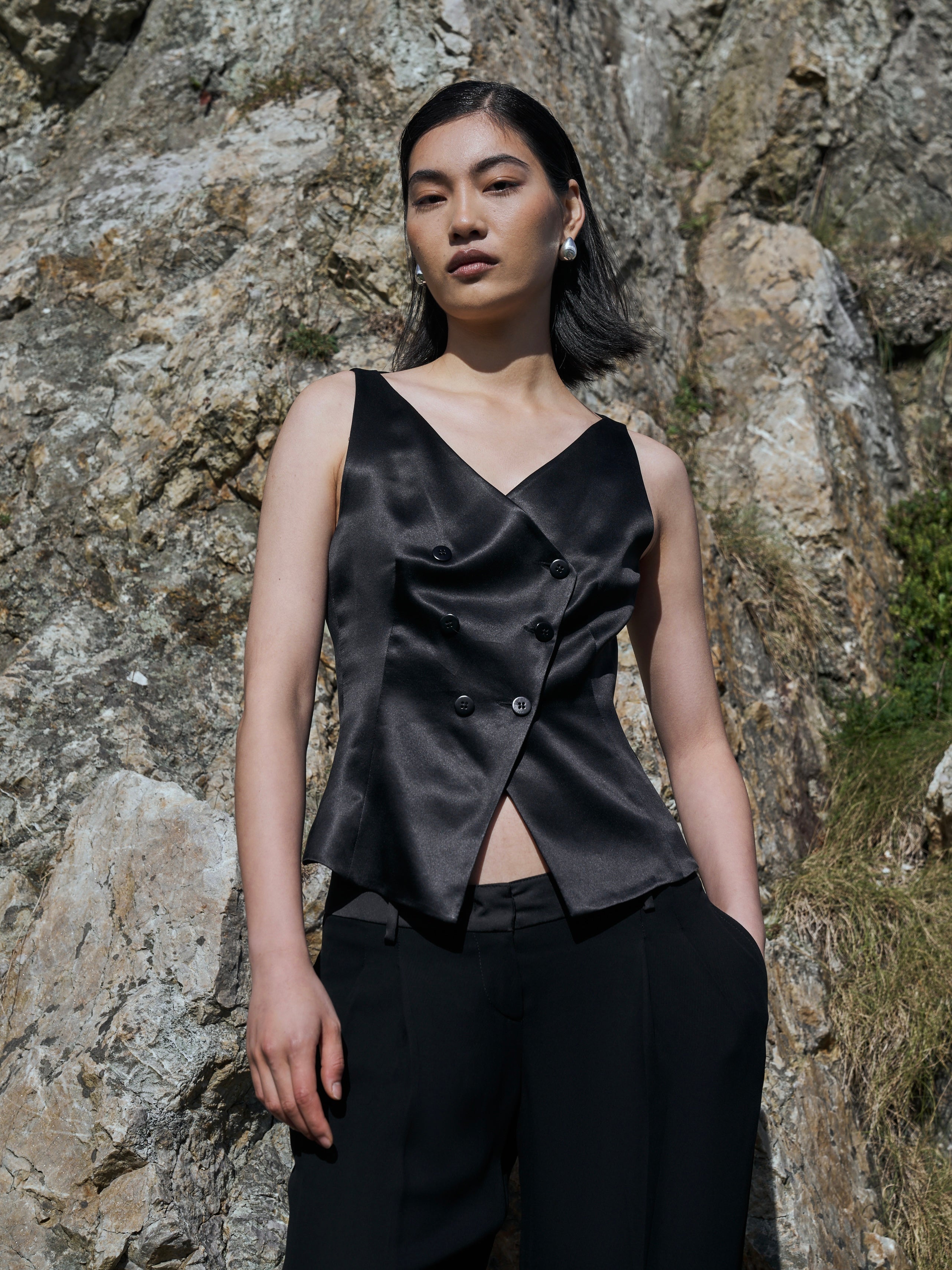 Valentino low waist wide-leg tuxedo trousers in black with tailored fit and crease detail, size W32, on a neutral background.