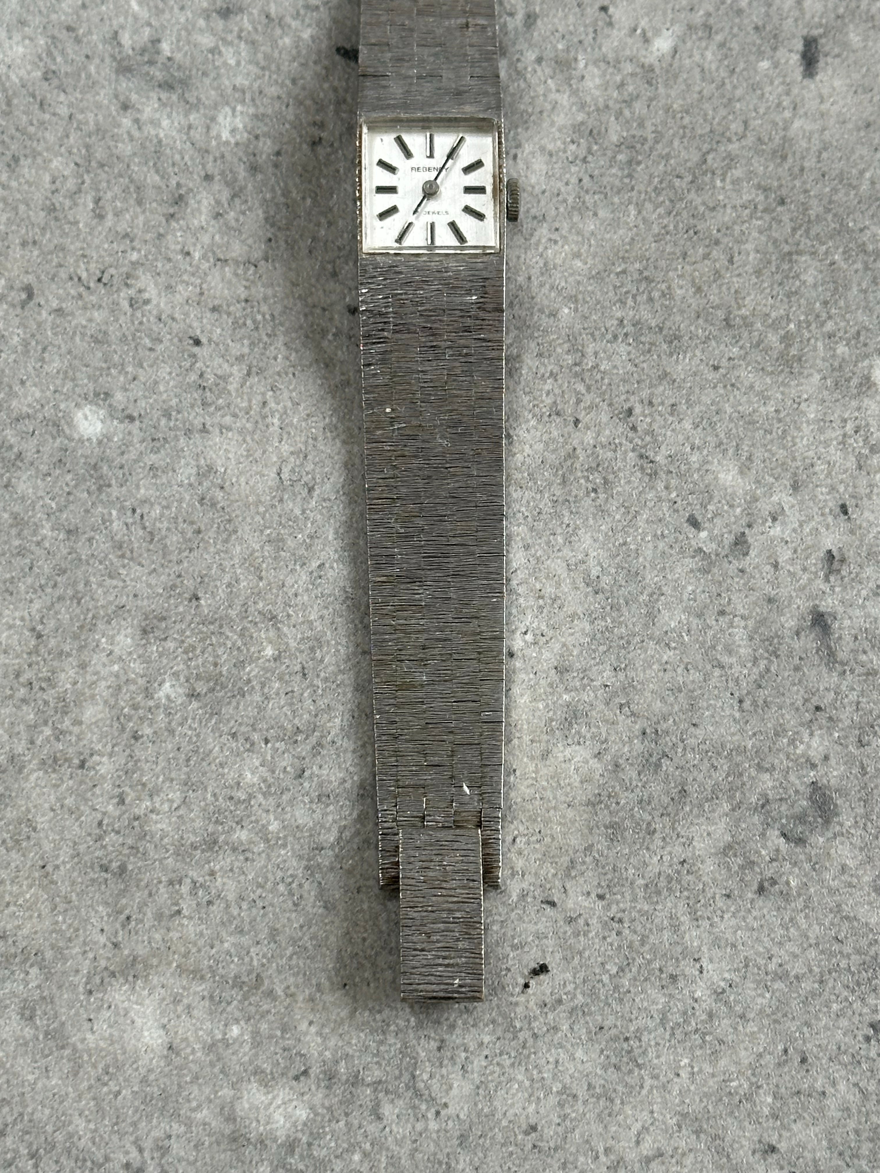 Vintage stainless steel square dial watch from the 1970s with a classic design and minimalist face.