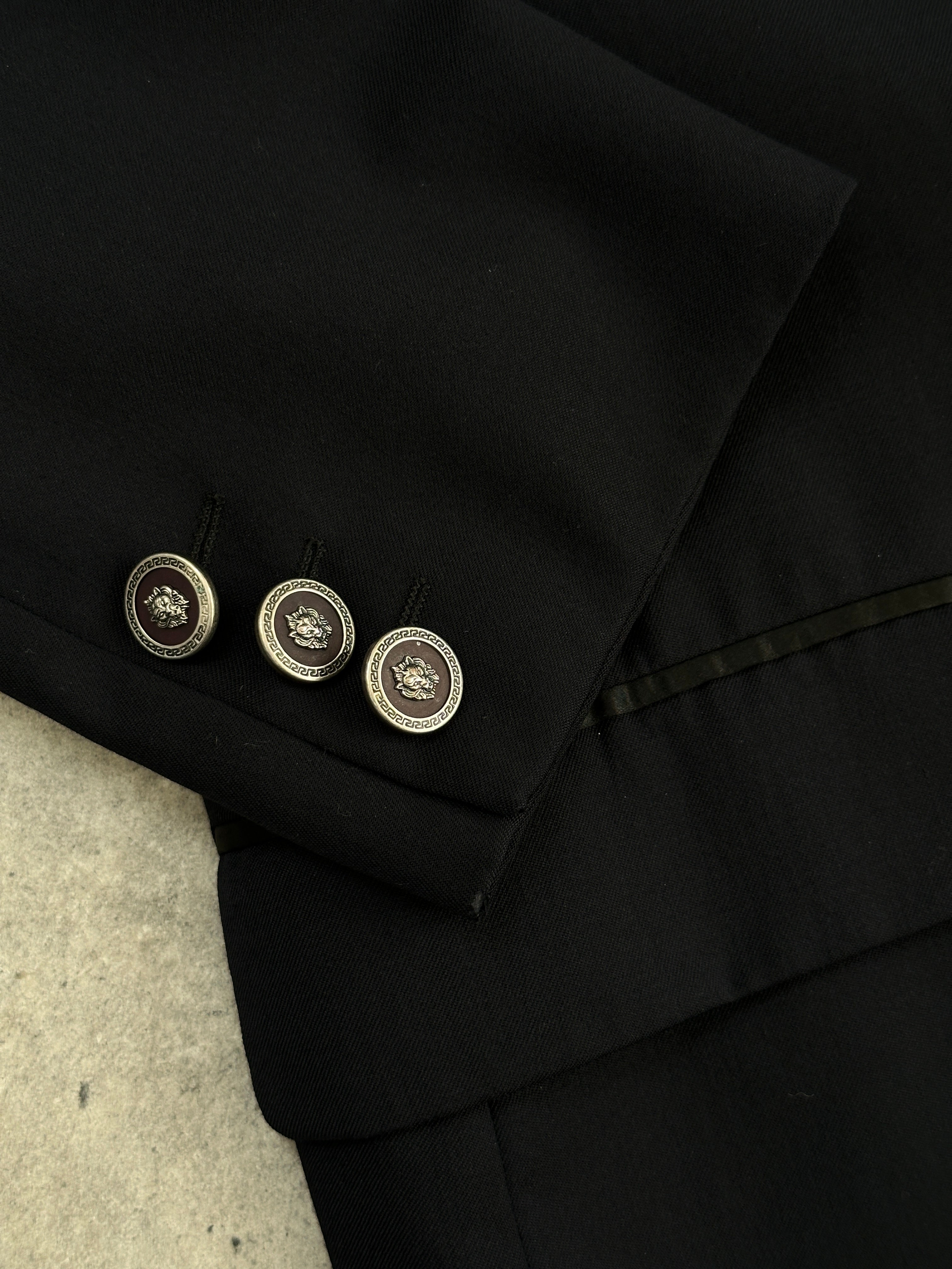 Versace Versus pure wool Medusa tuxedo suit, size 40R/W32, featuring a tailored black jacket with Medusa logo details.