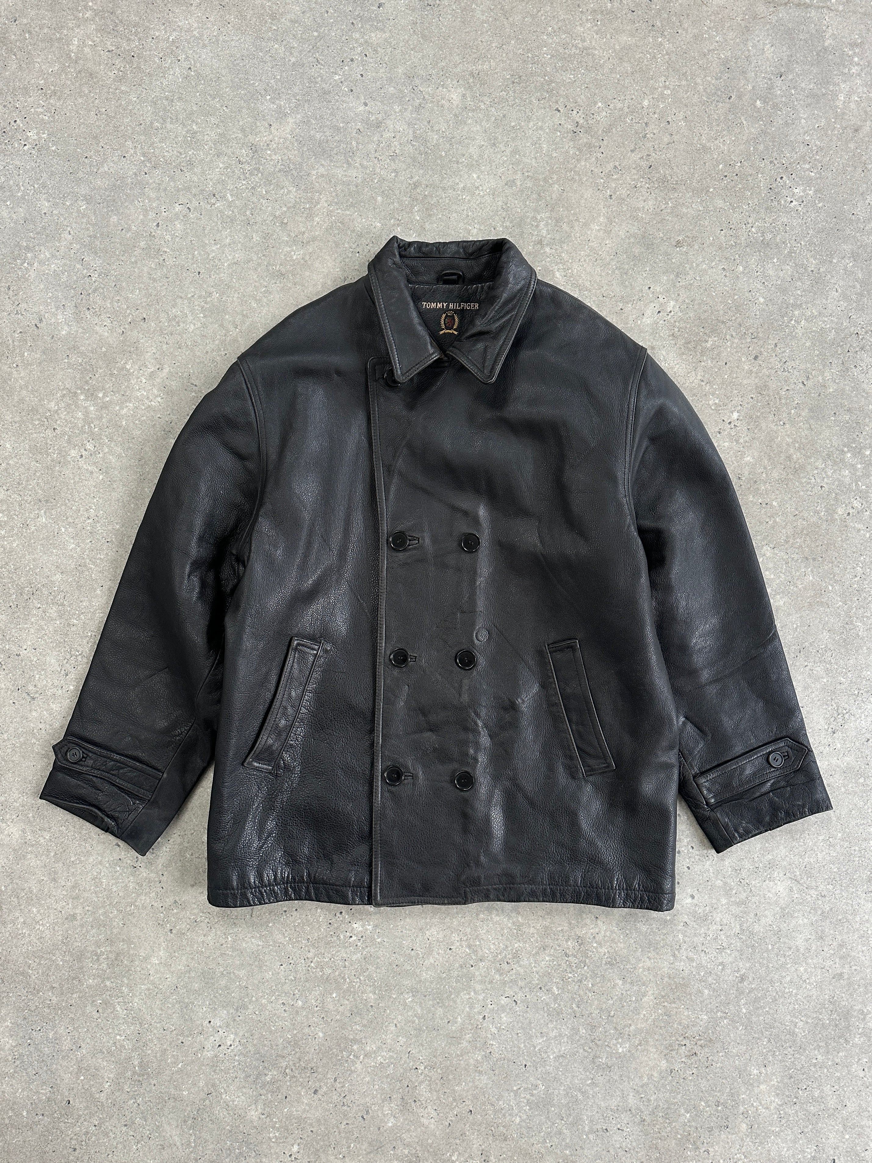 Tommy Hilfiger double-breasted leather jacket in XL, black with silver buttons and classic collar, displayed on a hanger.