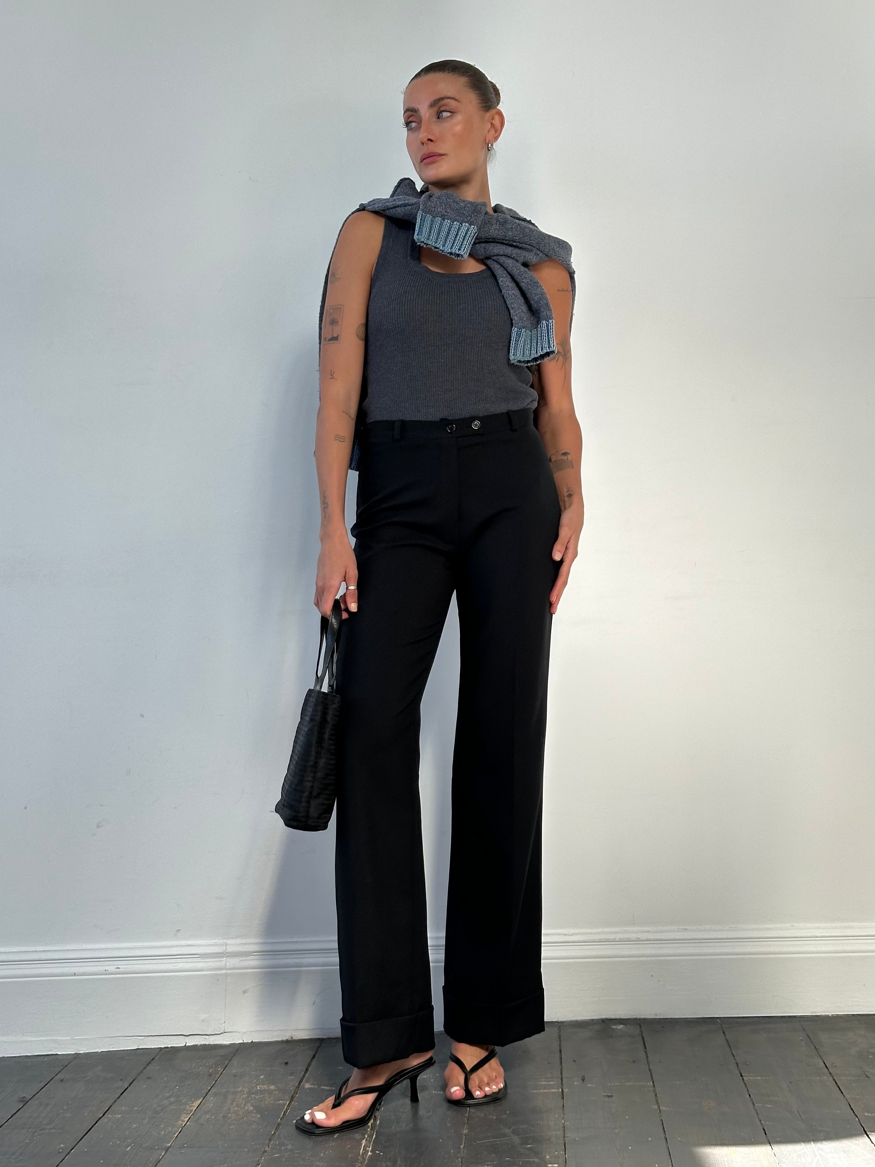 Vintage Italian vintage mid-waisted straight-leg tailored trousers in size W28, shown hanging with a classic design.