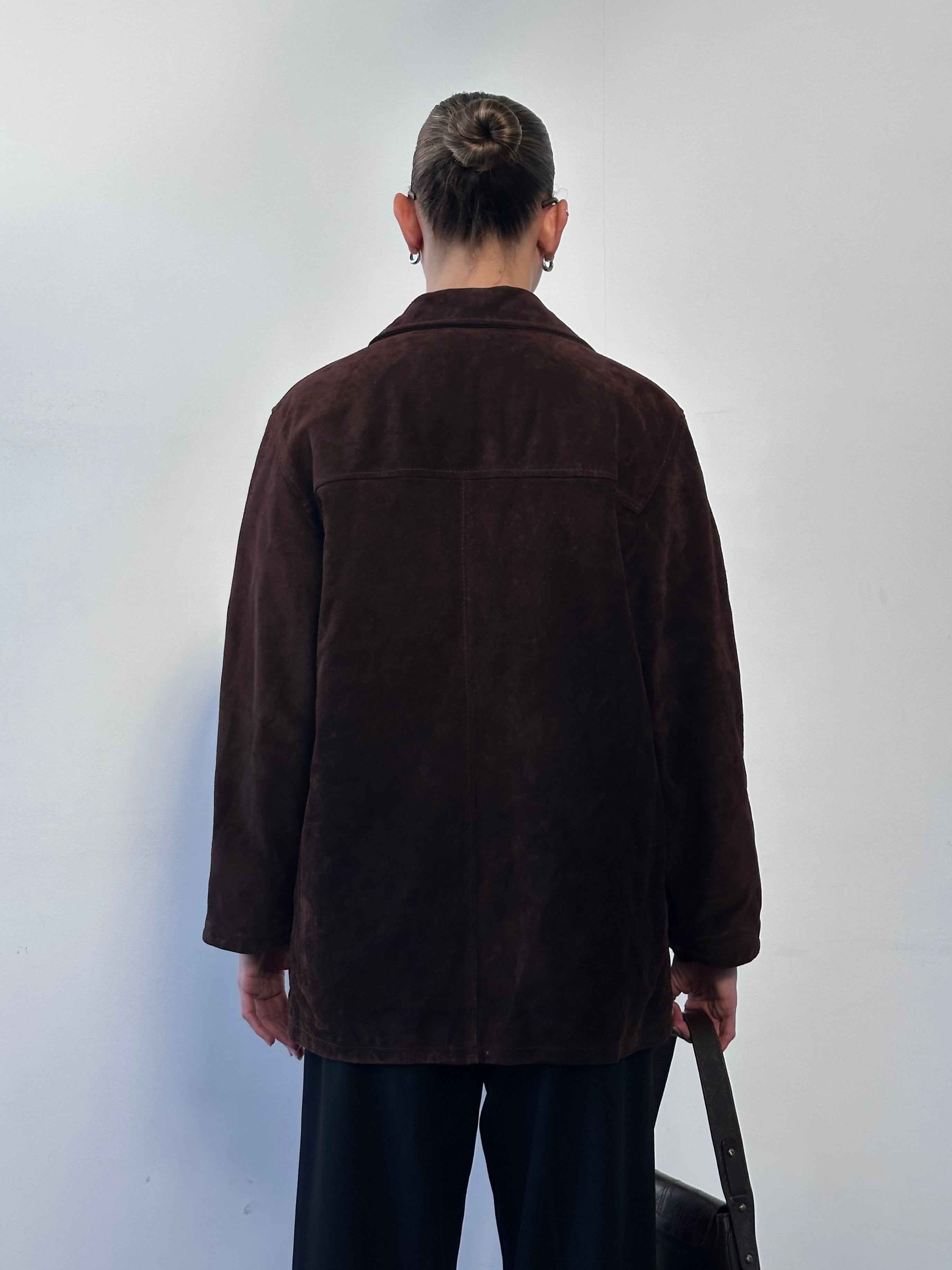 Vintage suede leather jacket in size M/L, featuring classic design and textured material, displayed on a hanger.