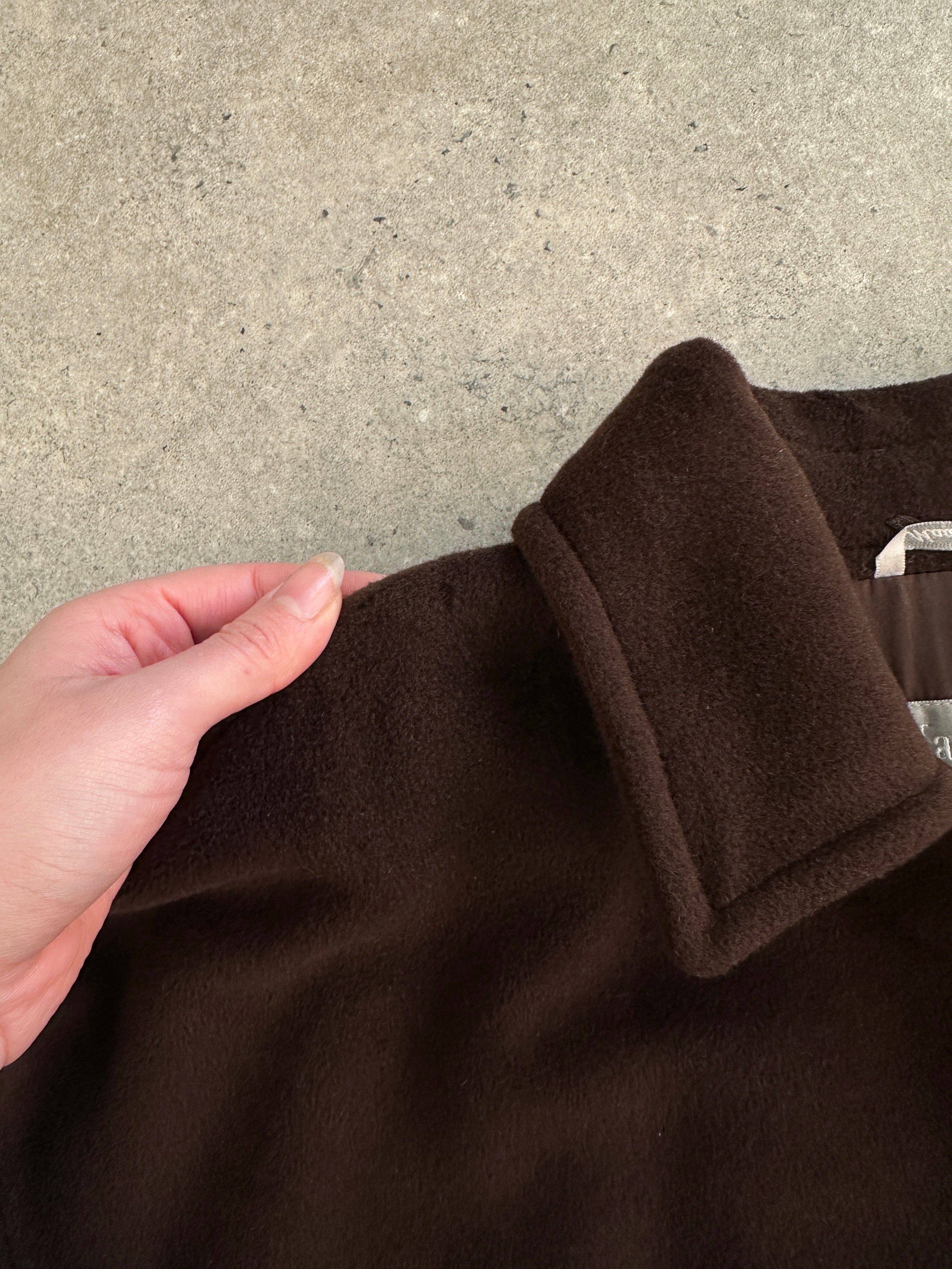 Max Mara pure virgin wool A-line coat in XL, shown hanging on a rack with a classic design and neutral color.