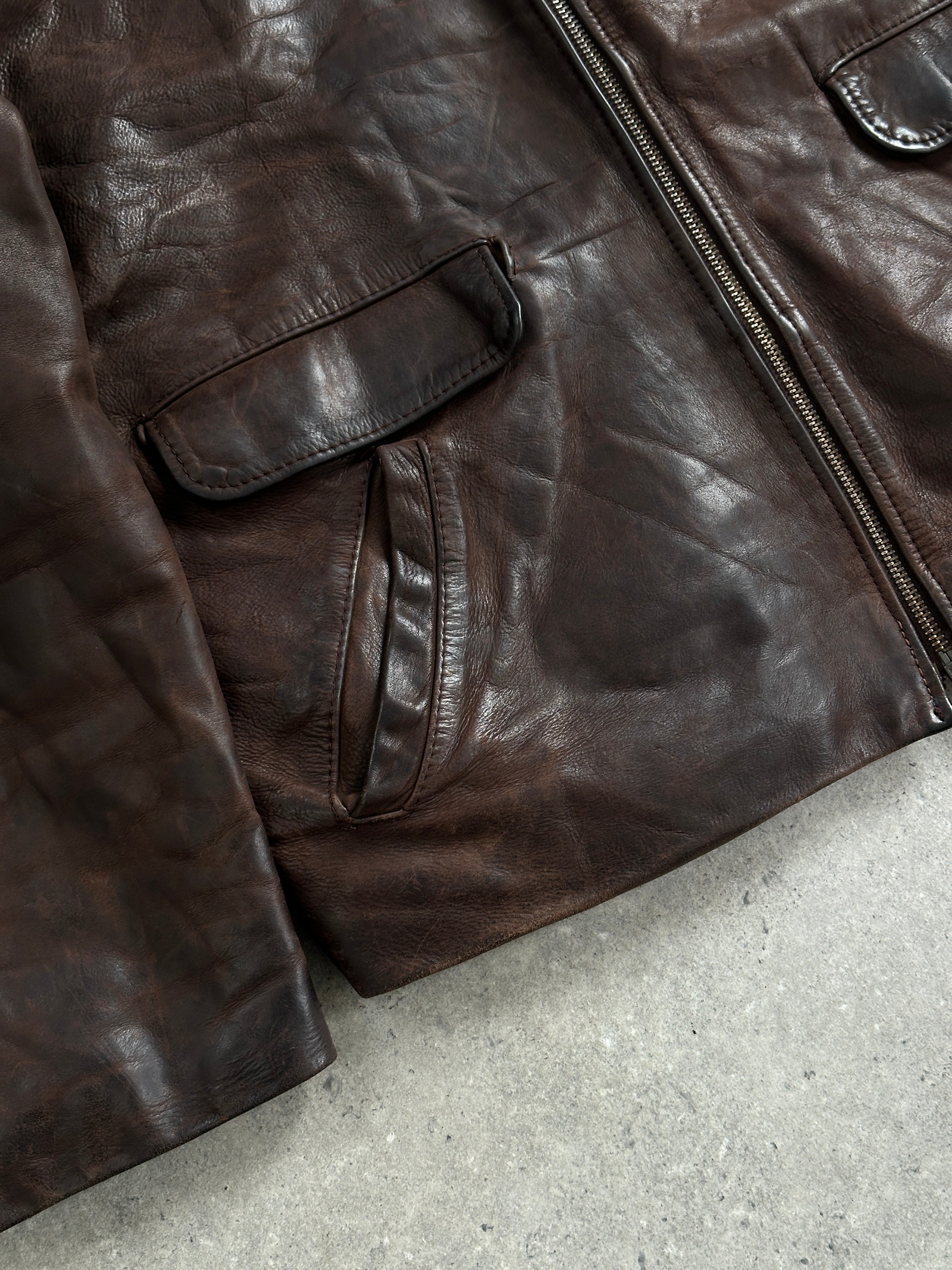 Vintage French 1980s aged boxy leather jacket in size L, featuring distressed brown leather and classic retro styling.