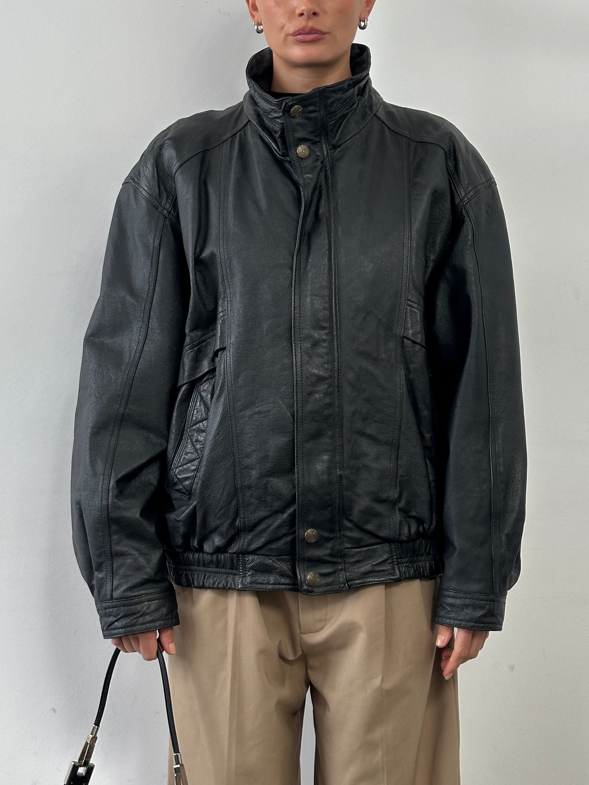 Vintage high neck leather bomber jacket in XL, showcasing classic black leather with a high collar and vintage style details.