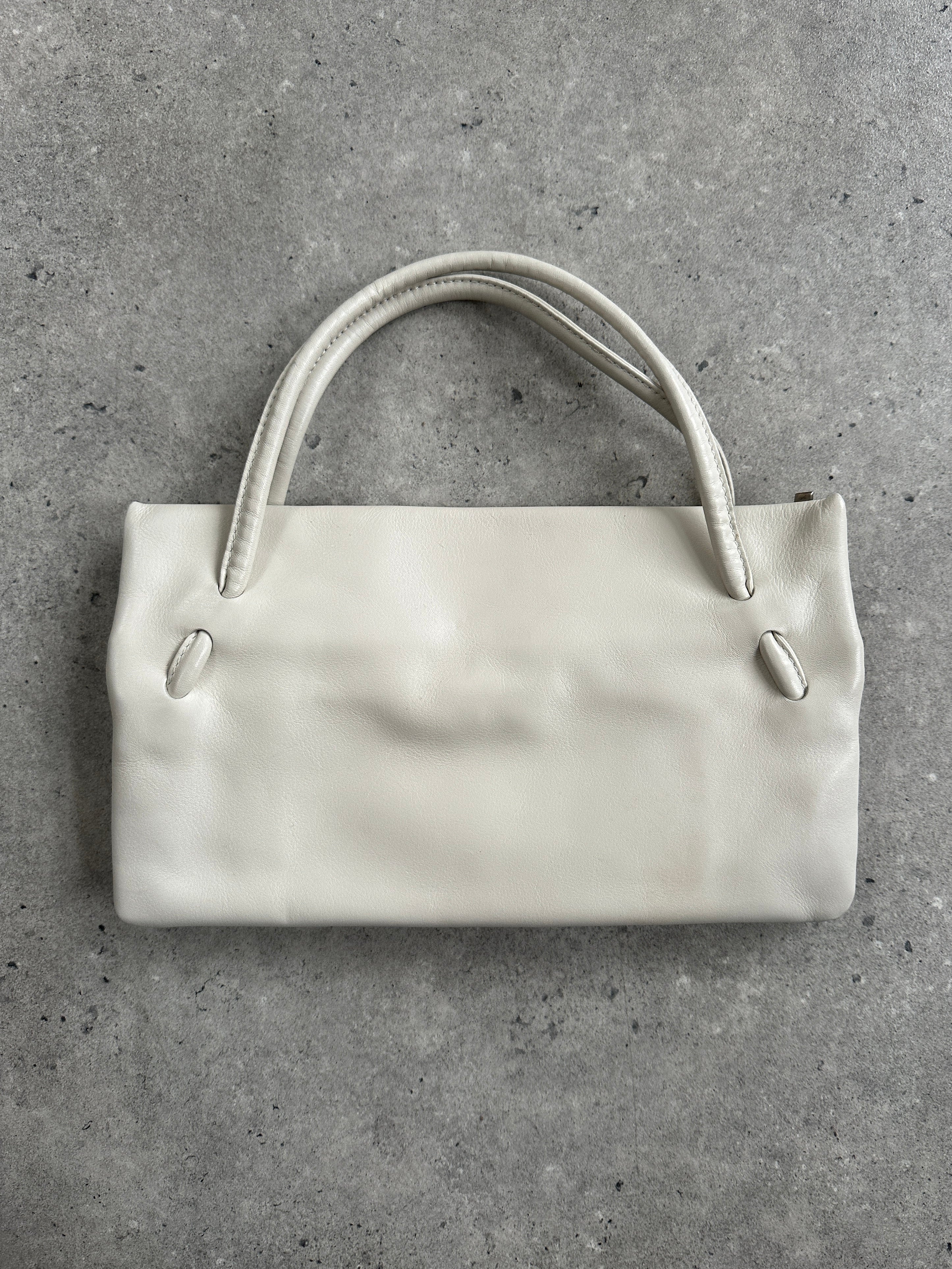 Giorgio Armani Le Collezioni embossed logo handbag with textured leather and elegant design, classic Armani style.