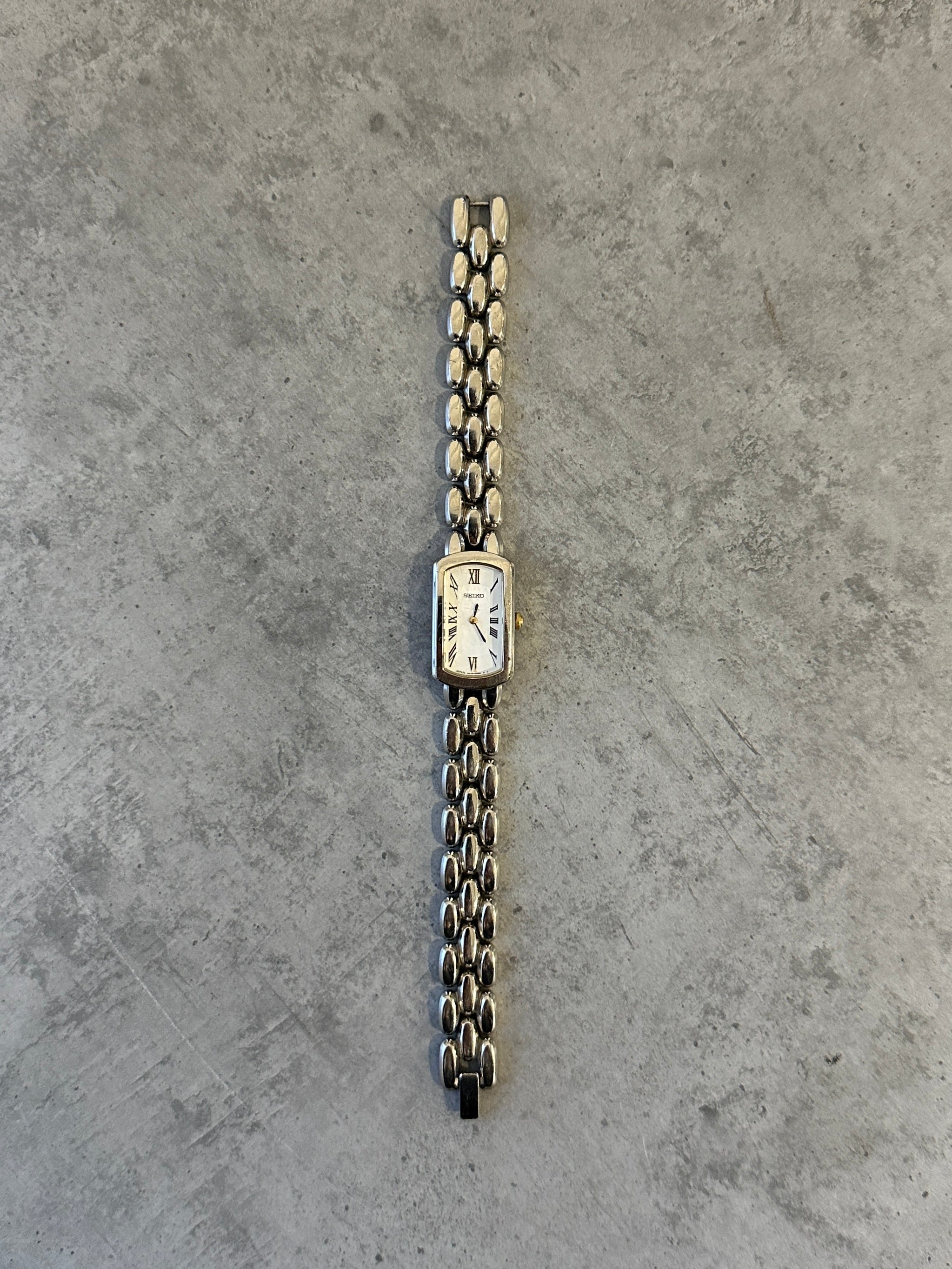 Seiko 1990s stainless steel rectangular quartz watch with a sleek design and silver-tone finish.