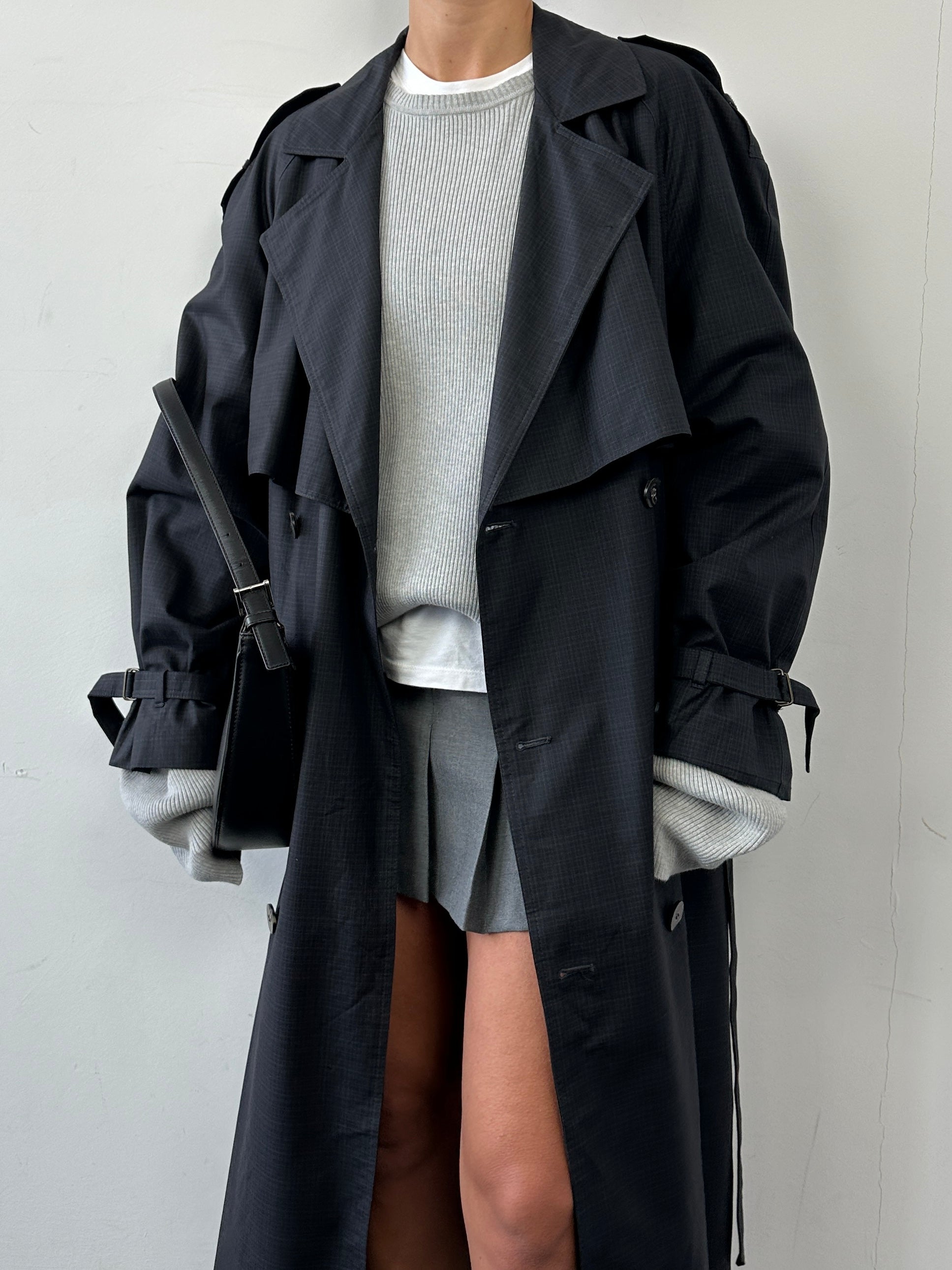 Christian Dior cotton double-breasted belted trench coat in XL displayed on a hanger, showcasing classic design and neutral color.