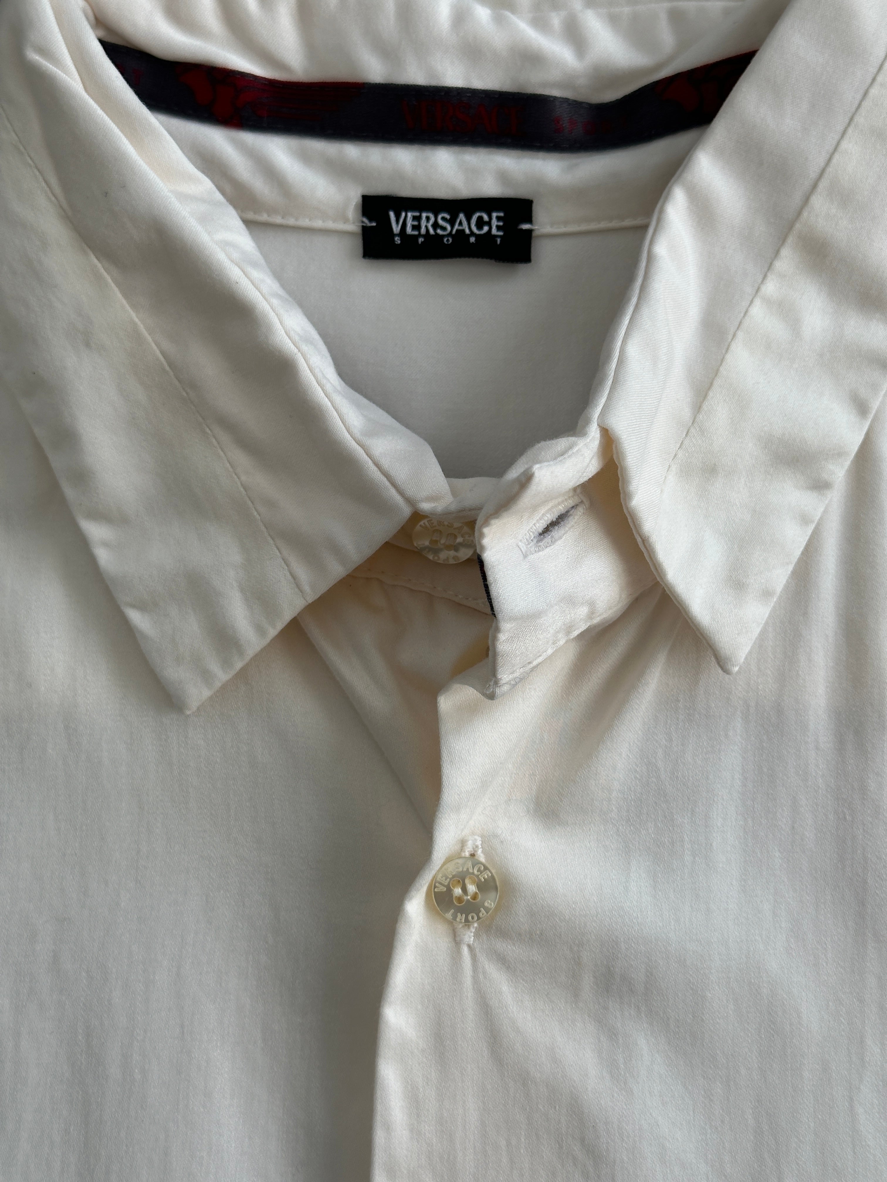 Versace Sport 90s pure cotton shirt in size L, featuring classic design and vibrant colors, displayed on a hanger.