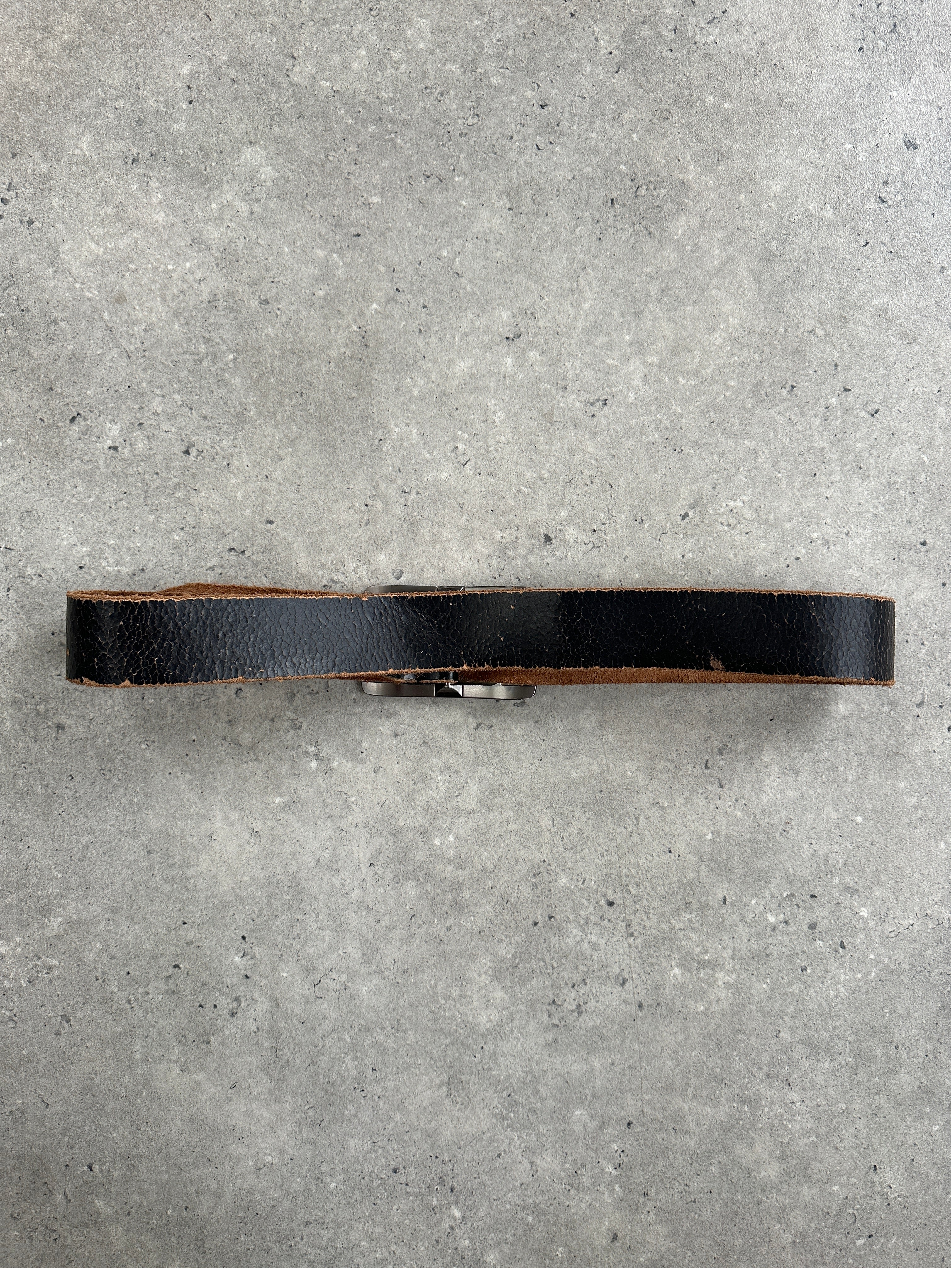 Vintage 1990s distressed leather belt, size W34-38, featuring a rugged, worn look with metal buckle, perfect for vintage style outfits.